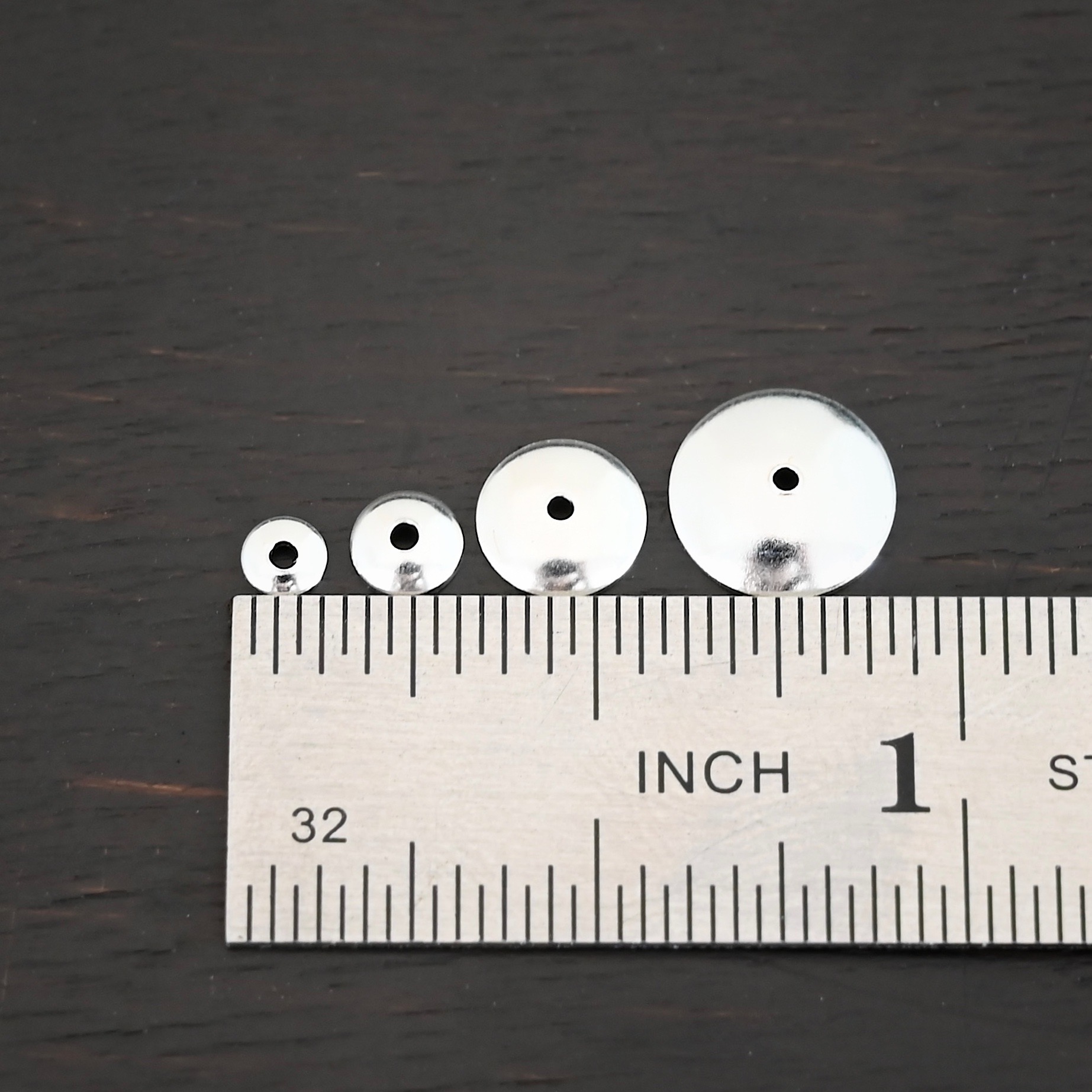 Silver shiny bead caps all sizes shown by ruler