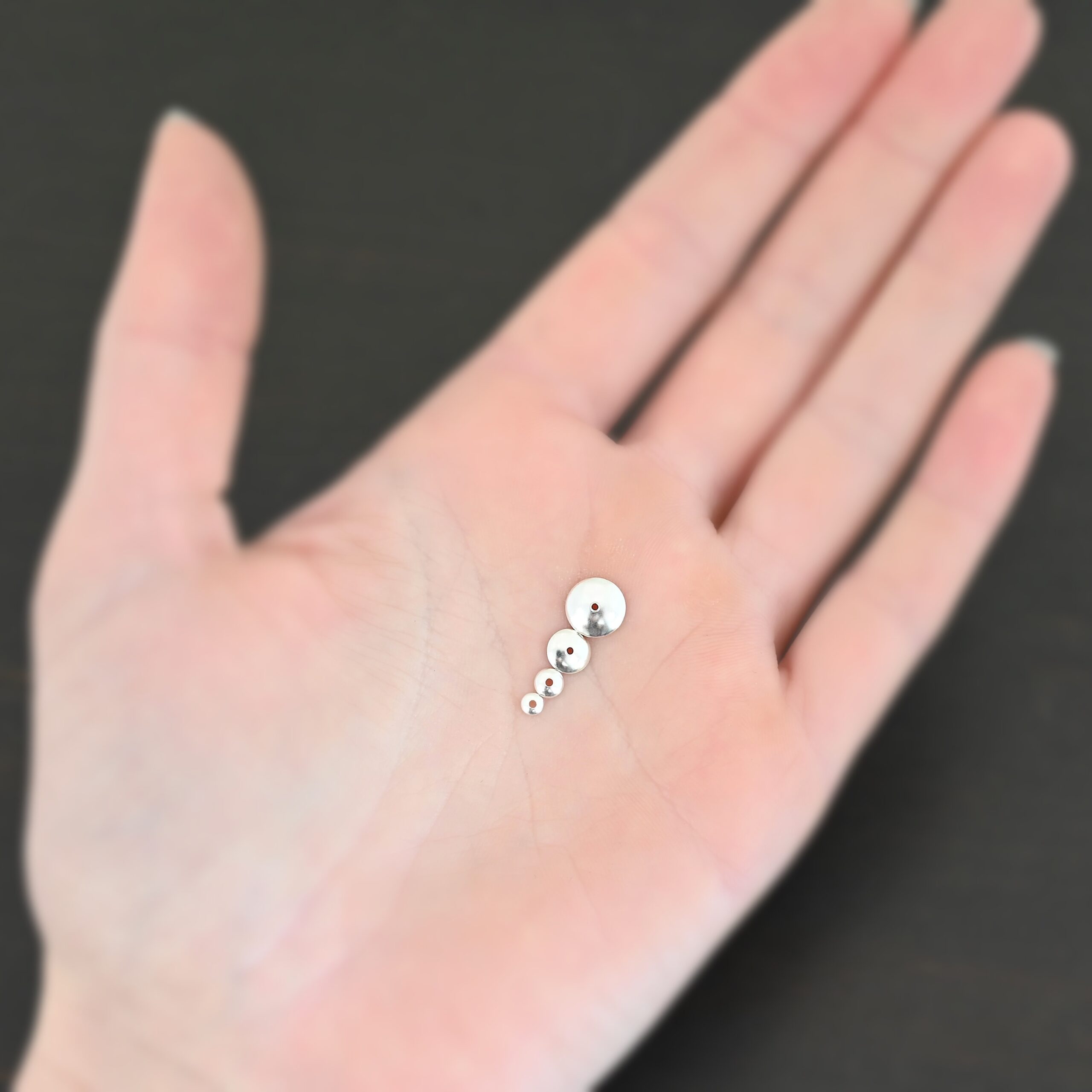 Silver shiny bead caps all sizes shown in hand