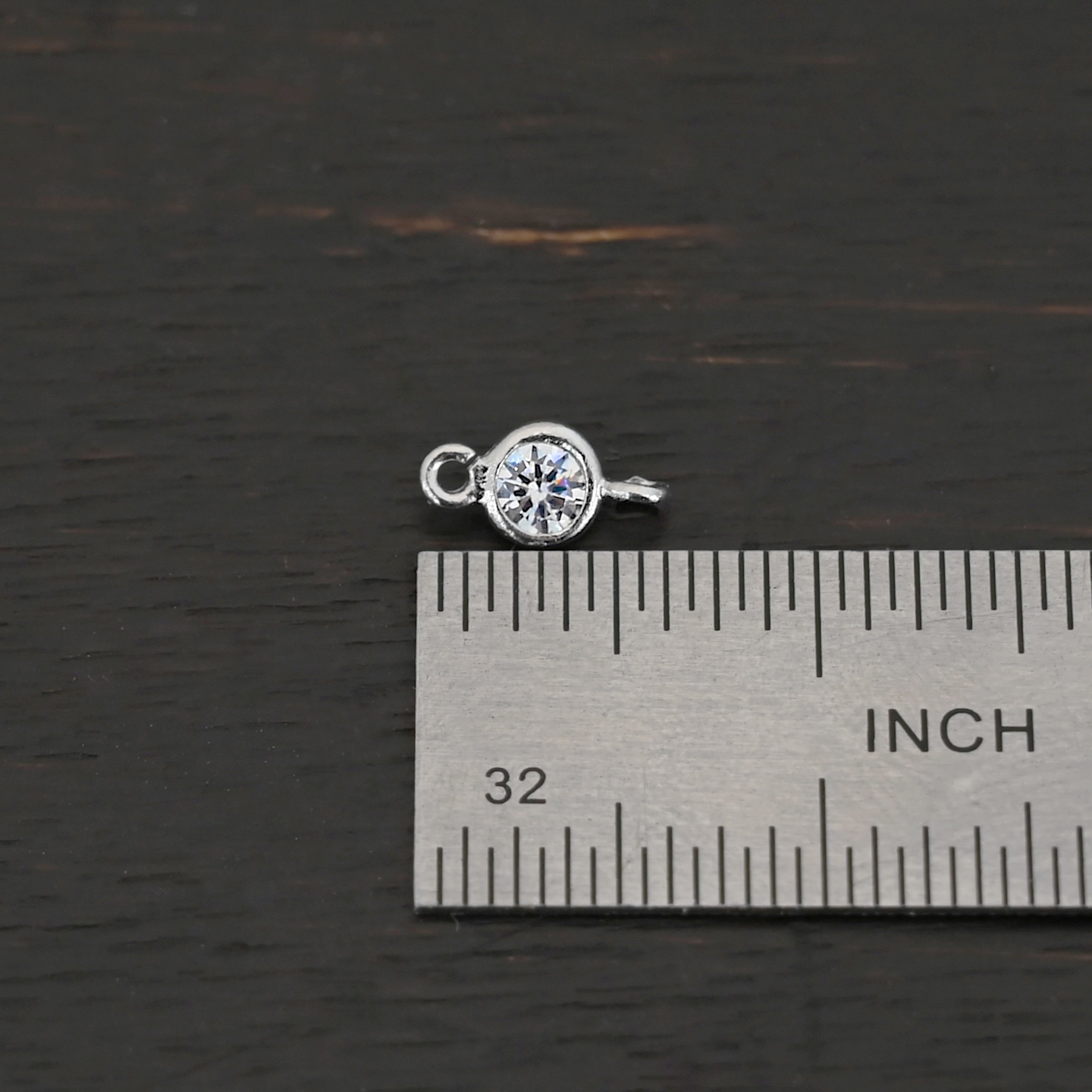 Silver Plated Cubic Zirconia link shown on by ruler