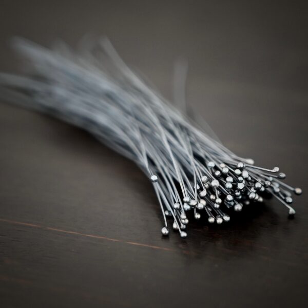 oxidized small ball headpins shown in dark background