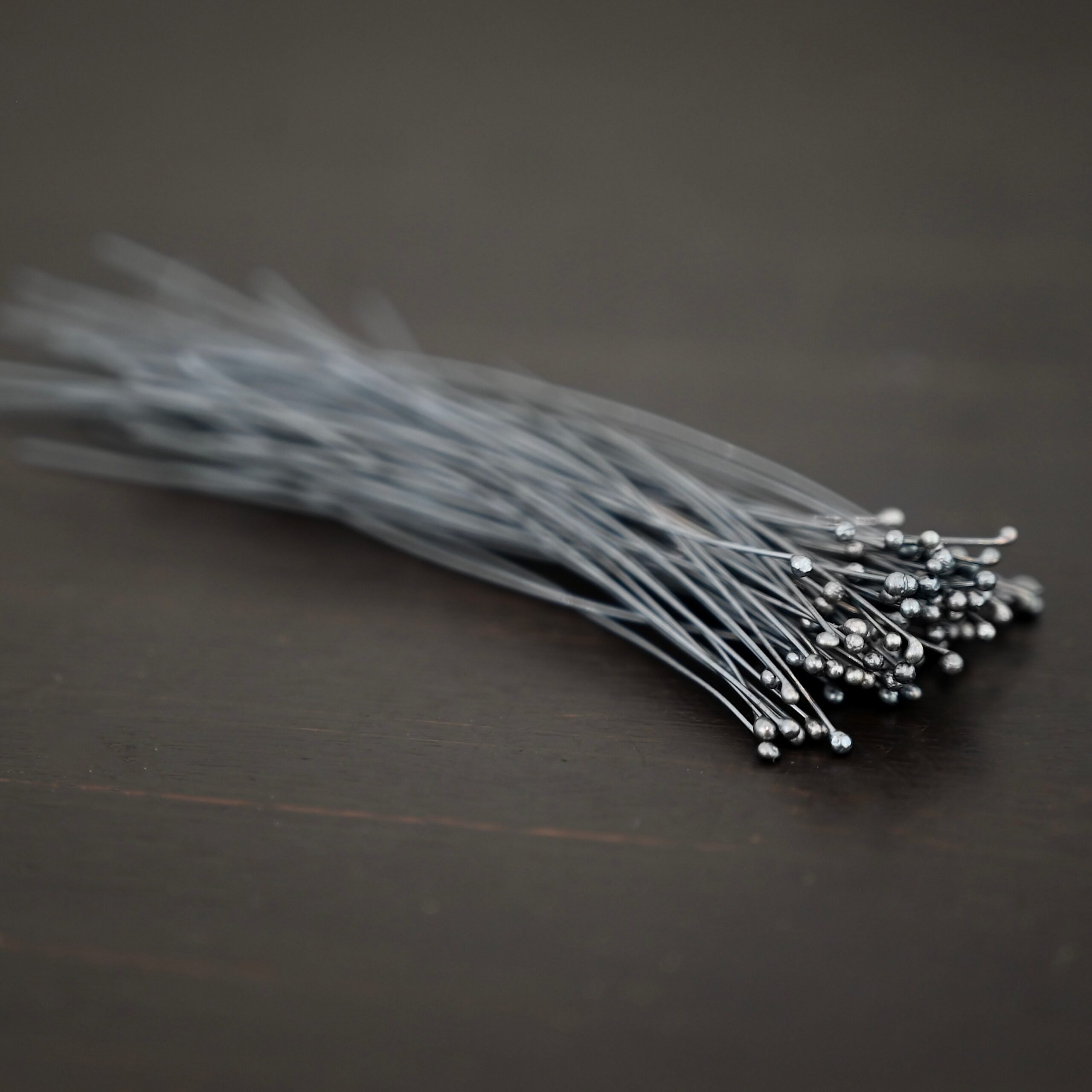 oxidized small ball headpins oxidized small ball headpins shown in dark background