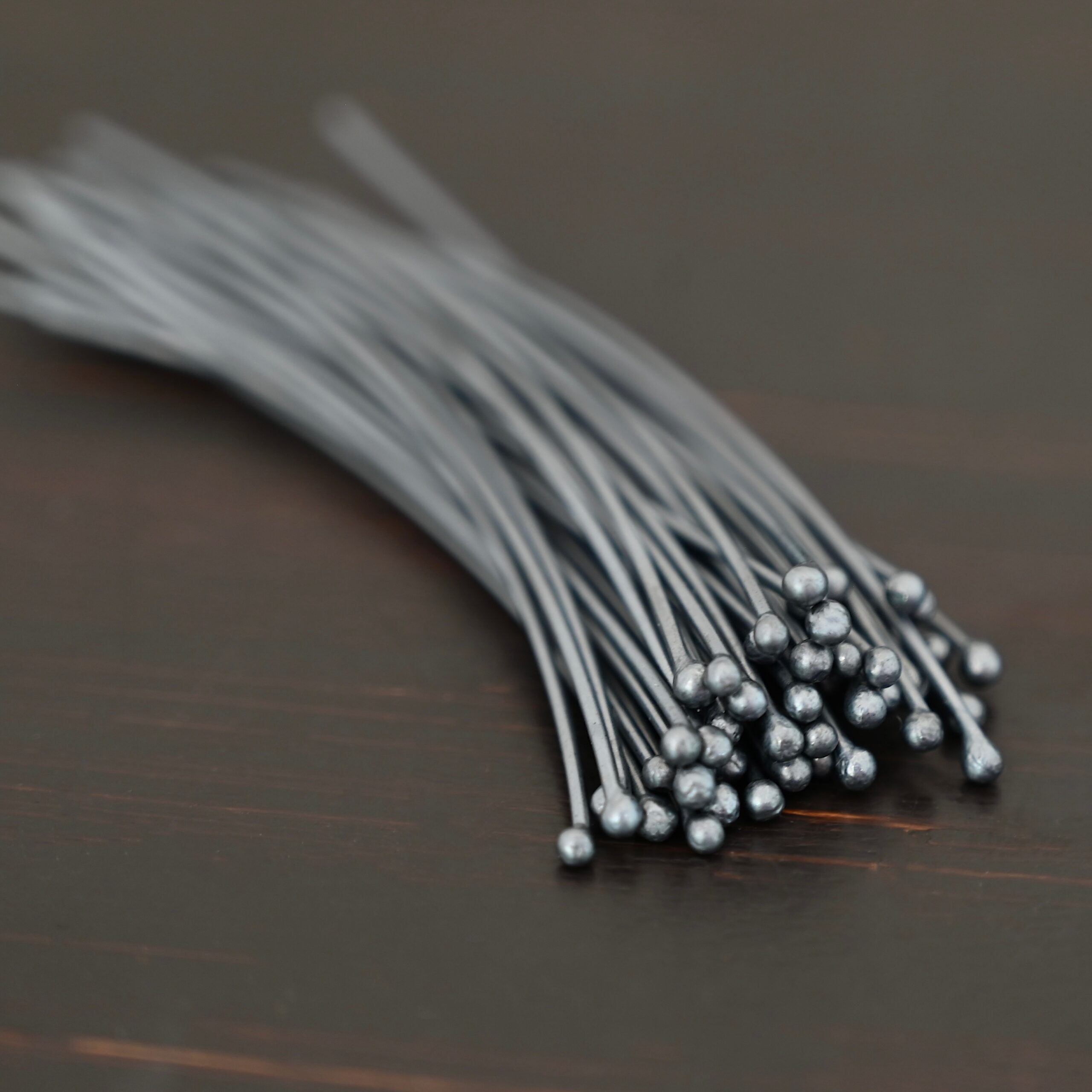Large Ball oxidized headpins shown on dark background