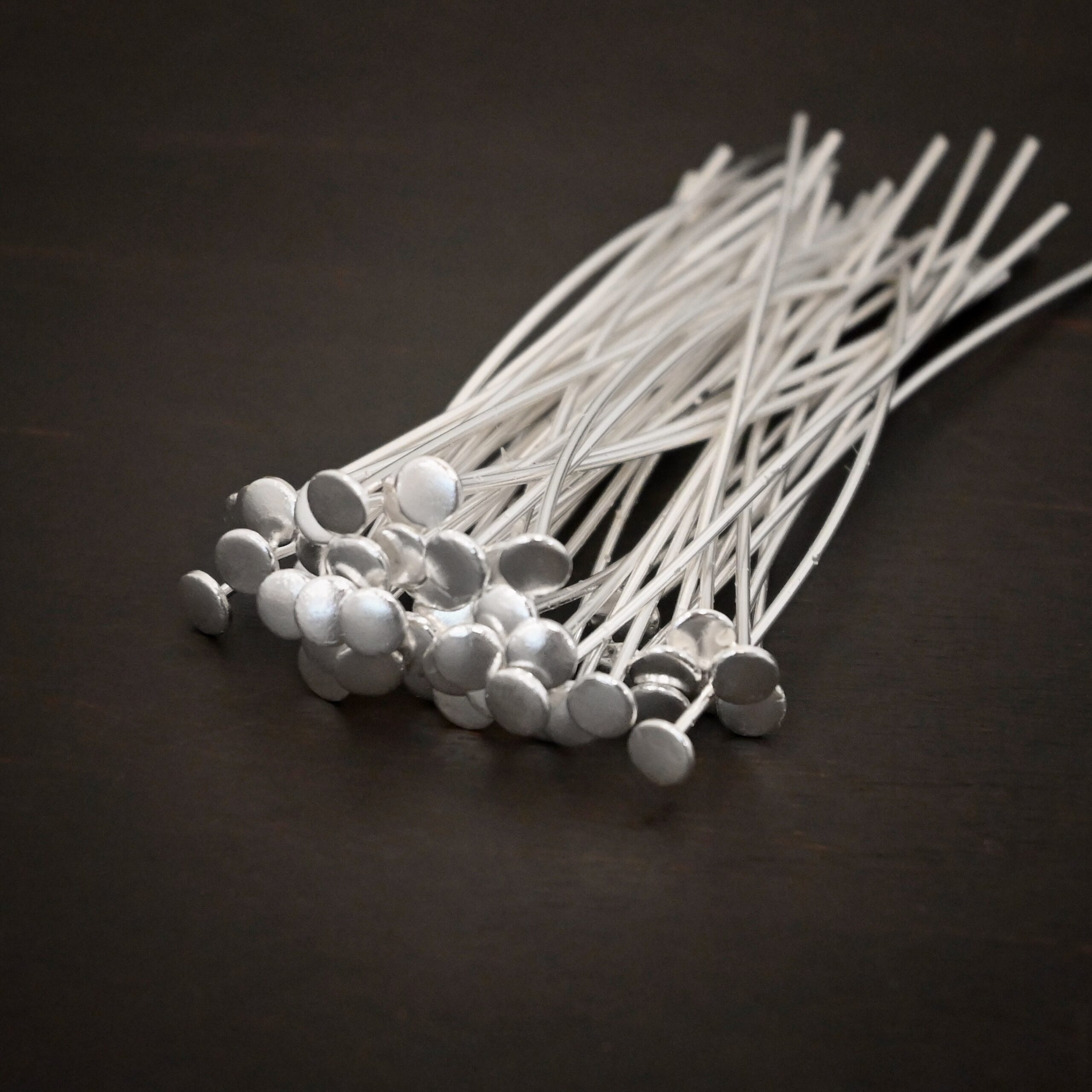 Silver Nail Headpins shown on dark background