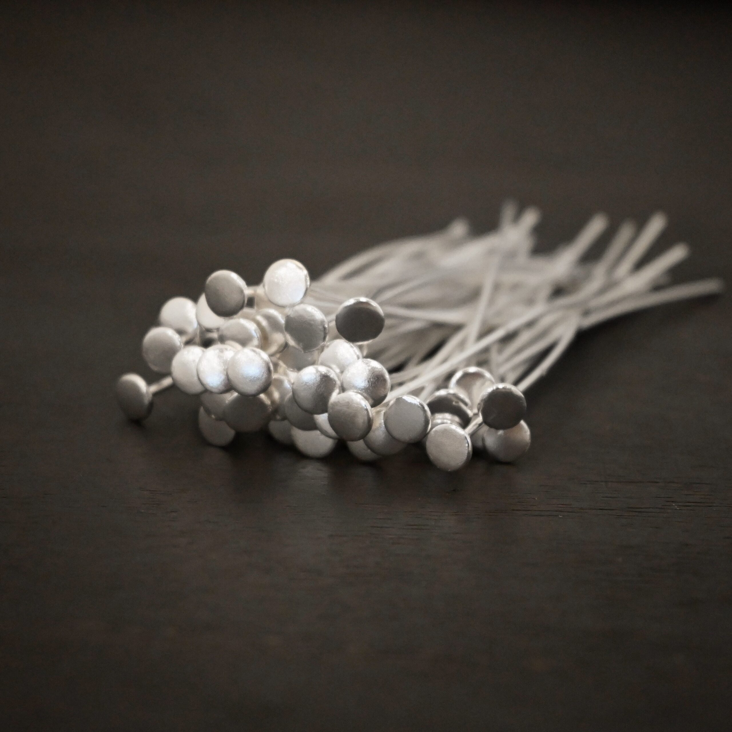 Silver Nail Headpins shown on dark background