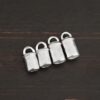 Handmade shiny end caps shown on dark background
