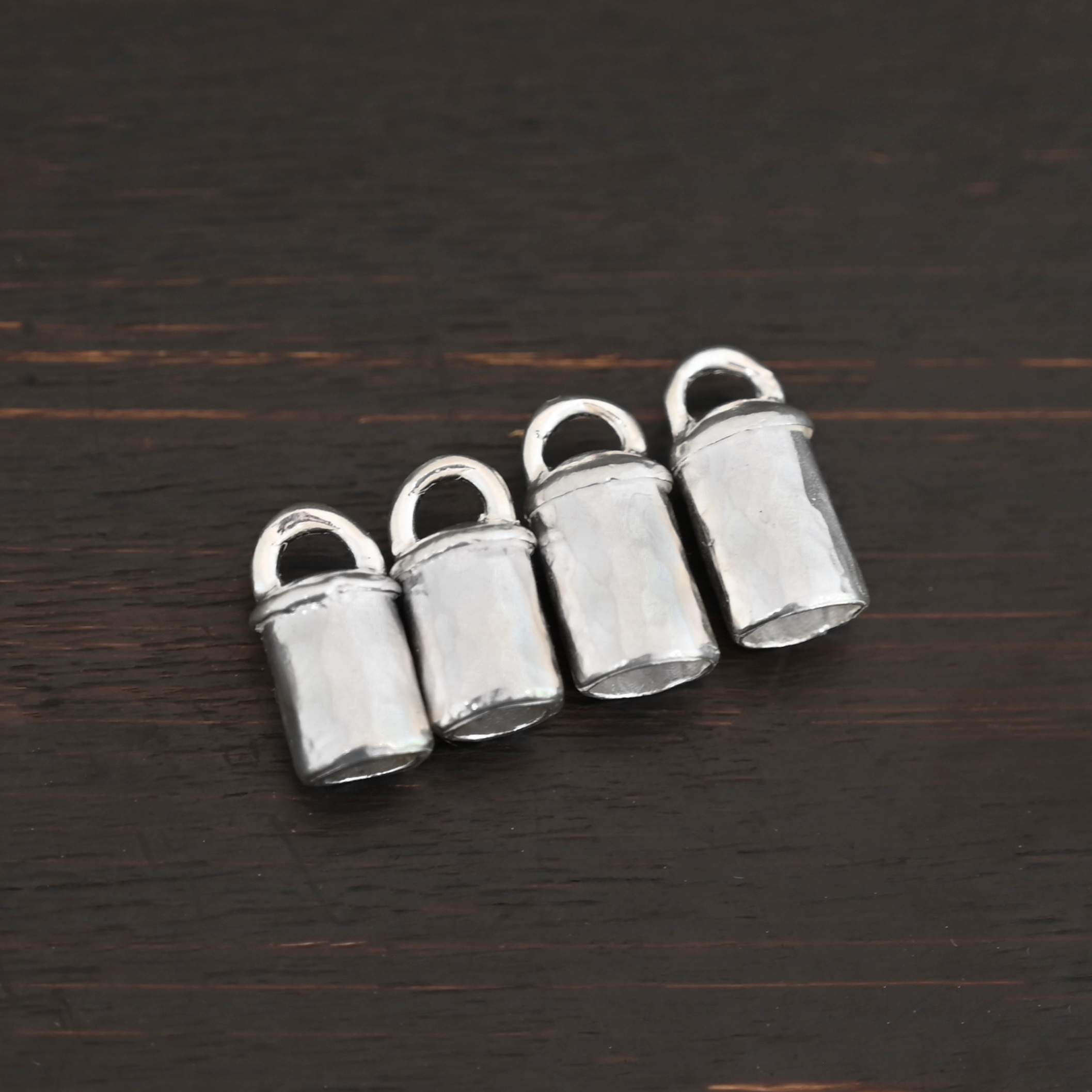 Handmade shiny end caps Handmade shiny end caps shown on dark background