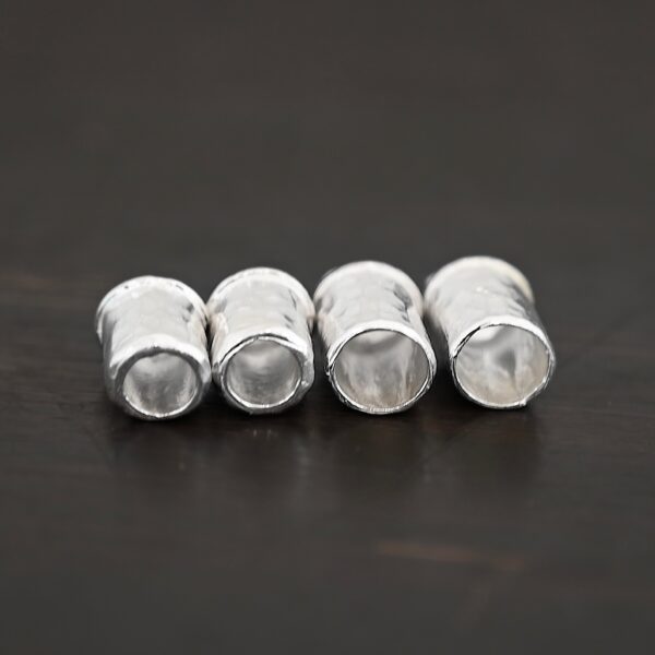 Handmade shiny end caps shown on dark background