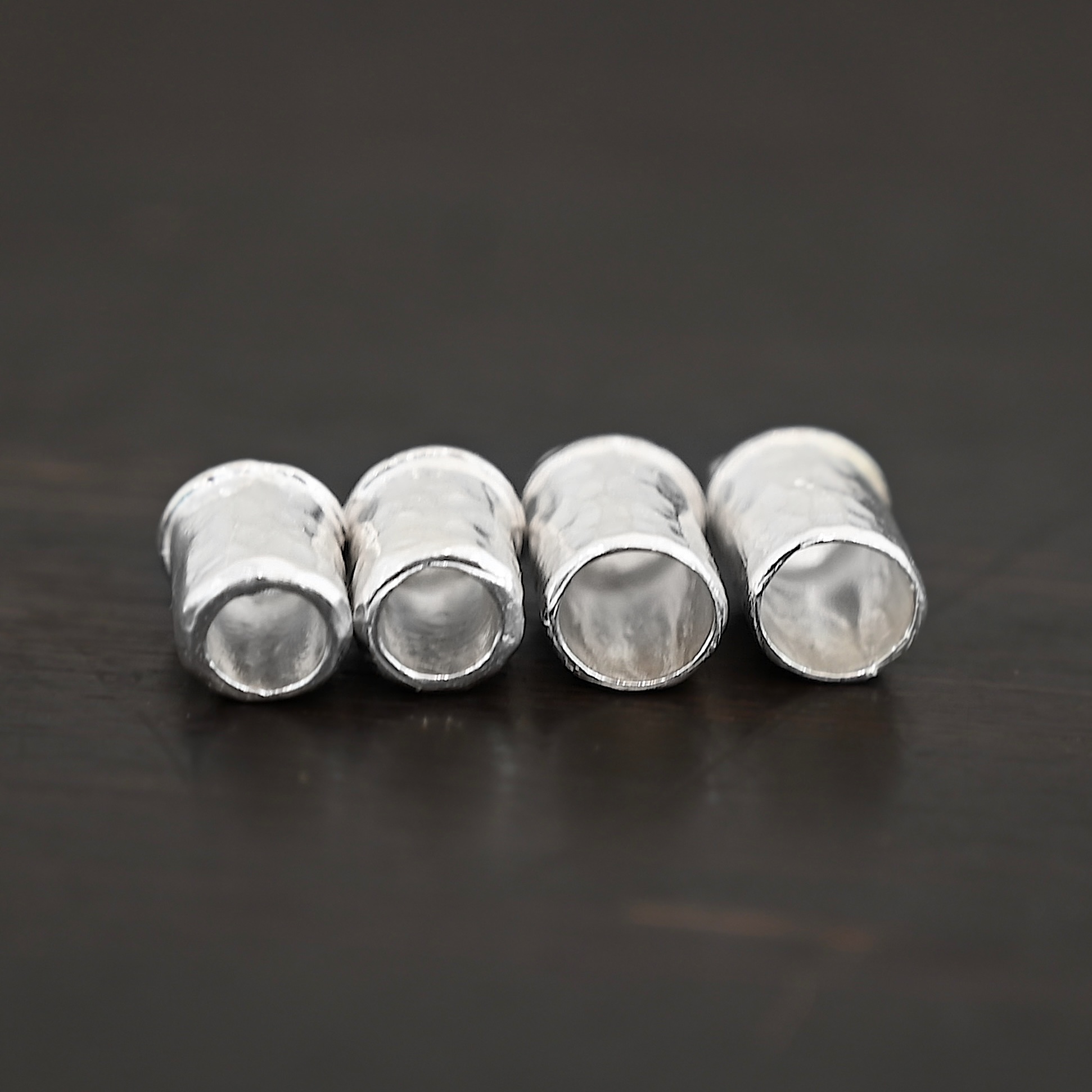 Handmade shiny end caps Handmade shiny end caps shown on dark background