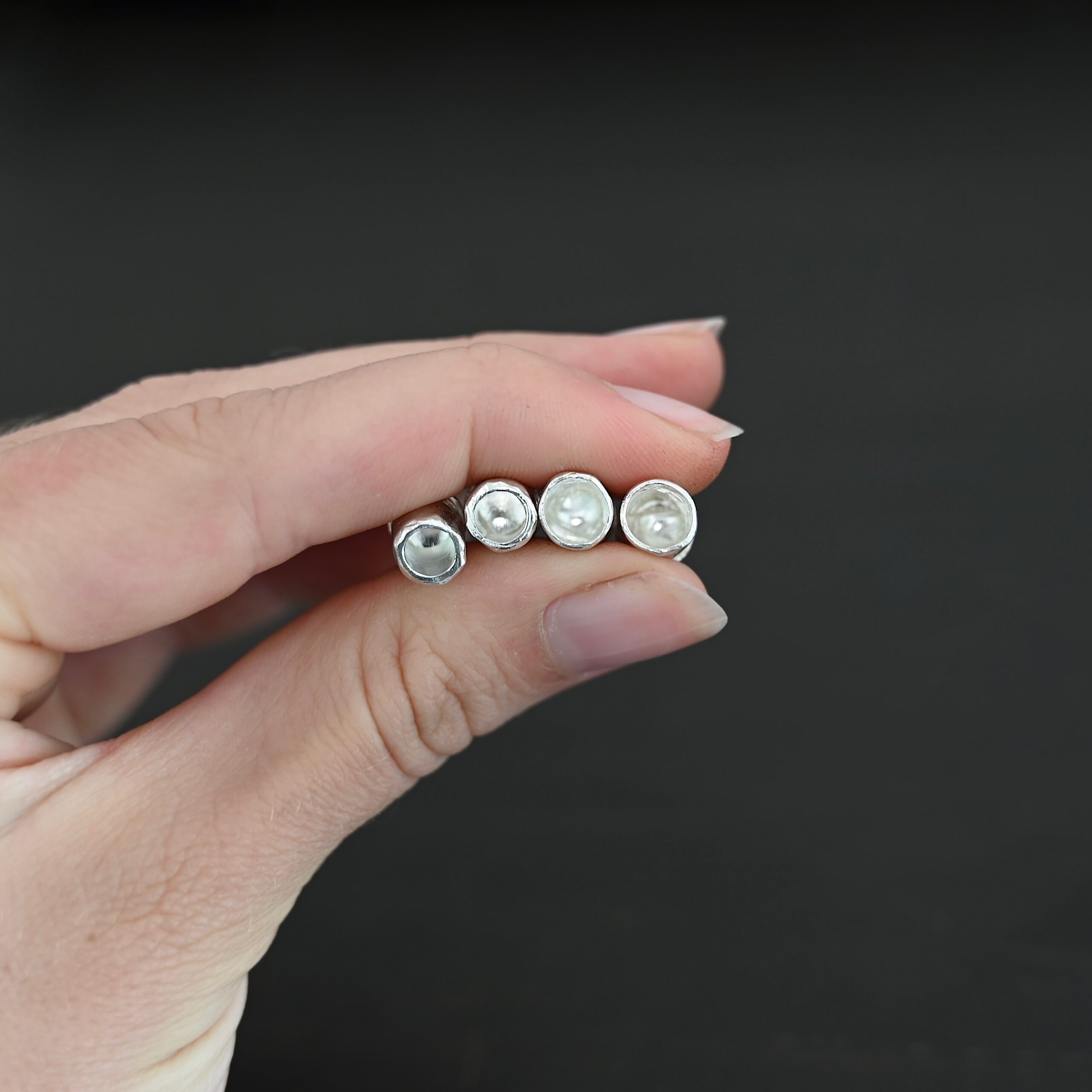 Handmade shiny end caps Handmade shiny end caps shown in hand