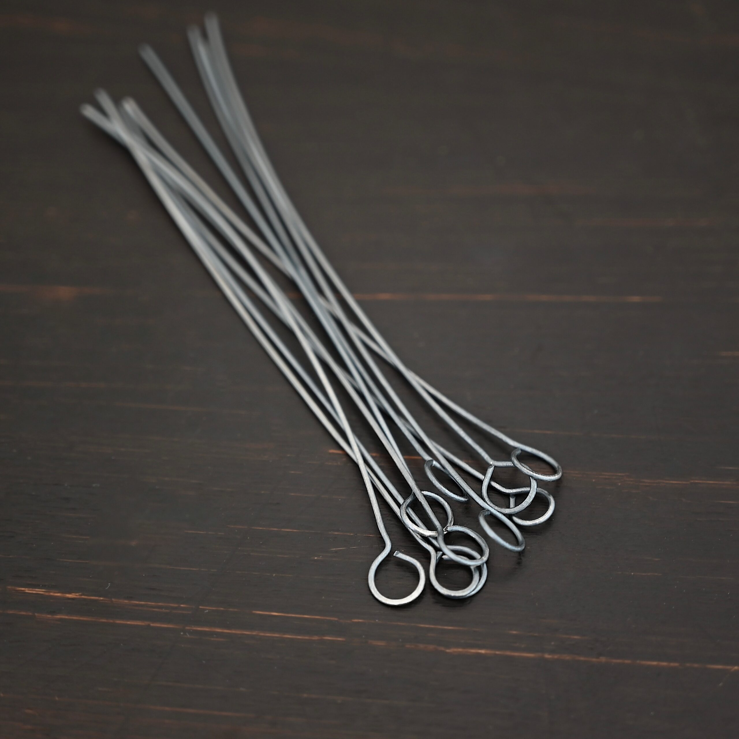 Eyepins oxidized 10pcs shown on dark background