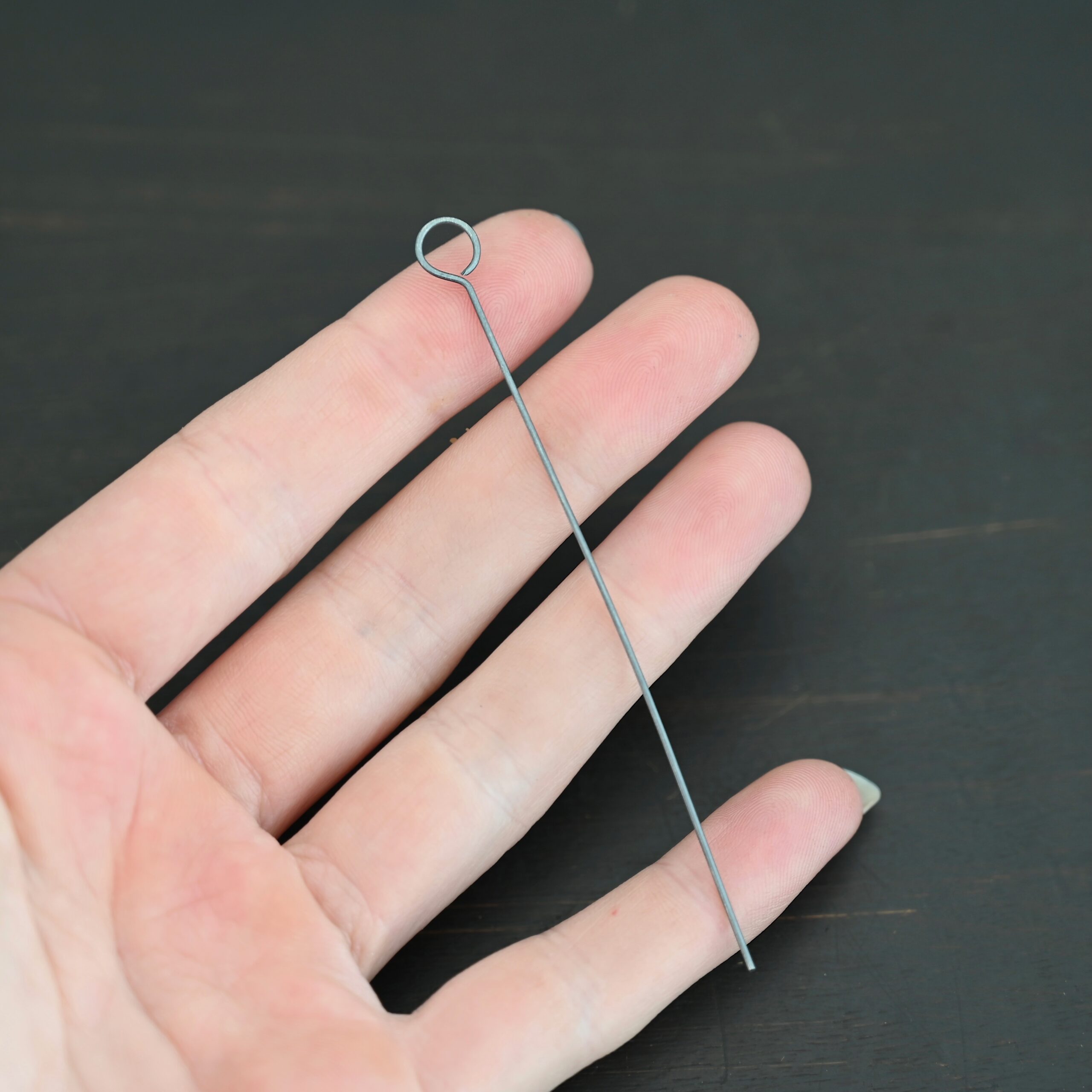 Eyepins oxidized 1pc shown in hand