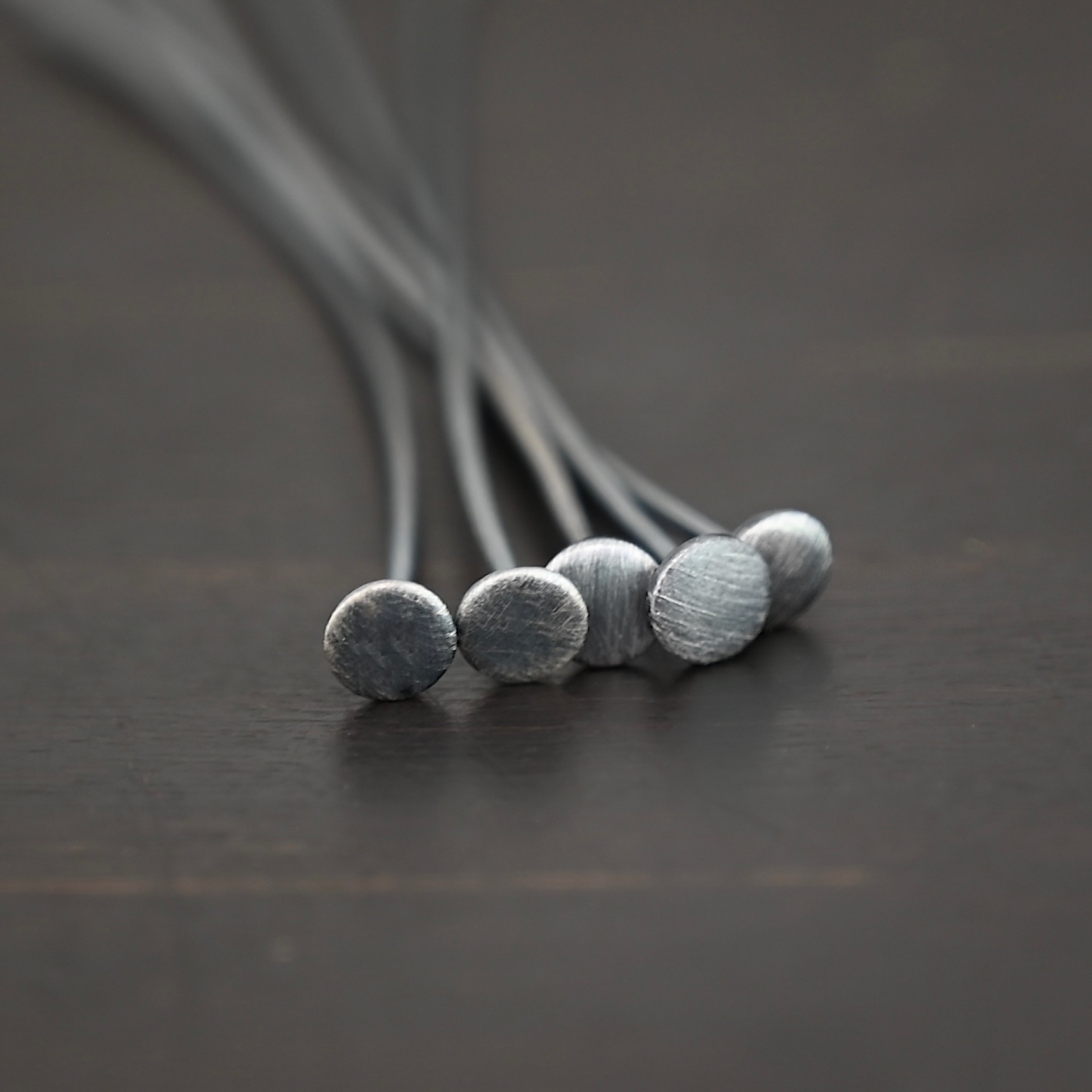 Nail Headpin oxidized 5mm shown on dark background