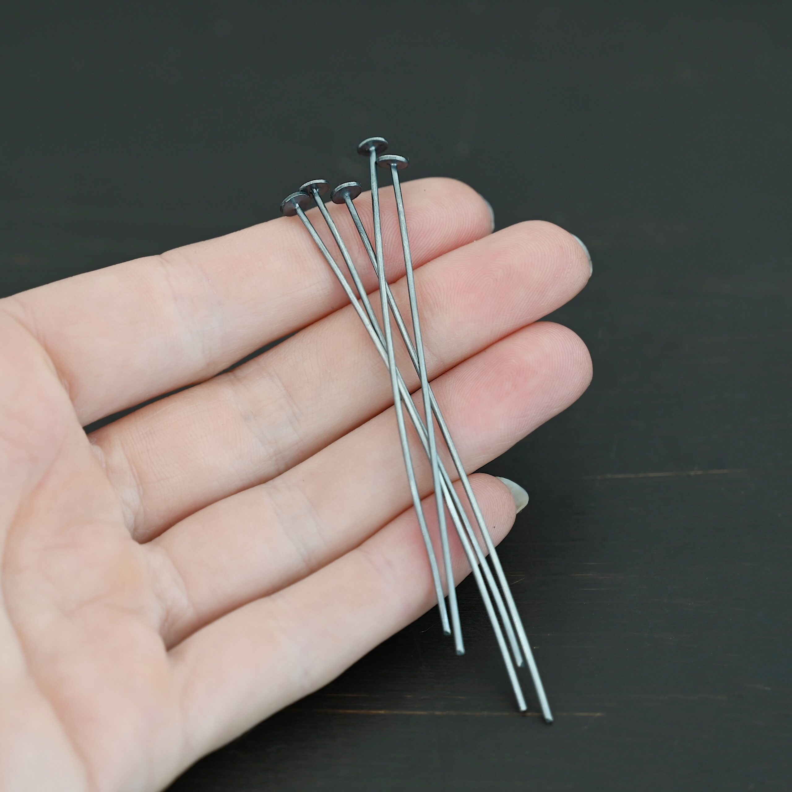 Nail Headpin 5mm oxidized shown in hand