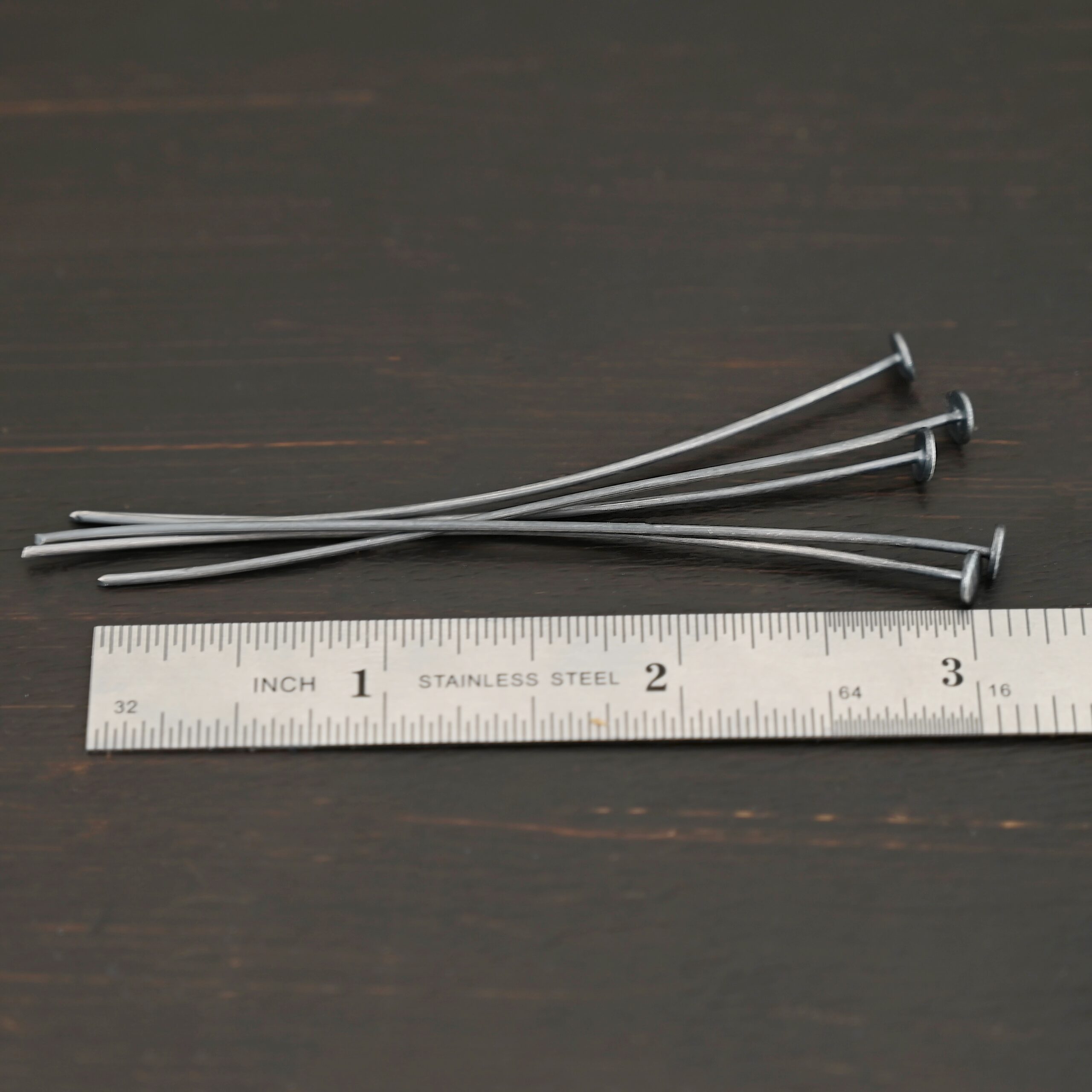 Nail Headpin 5mm oxidized shown by ruler