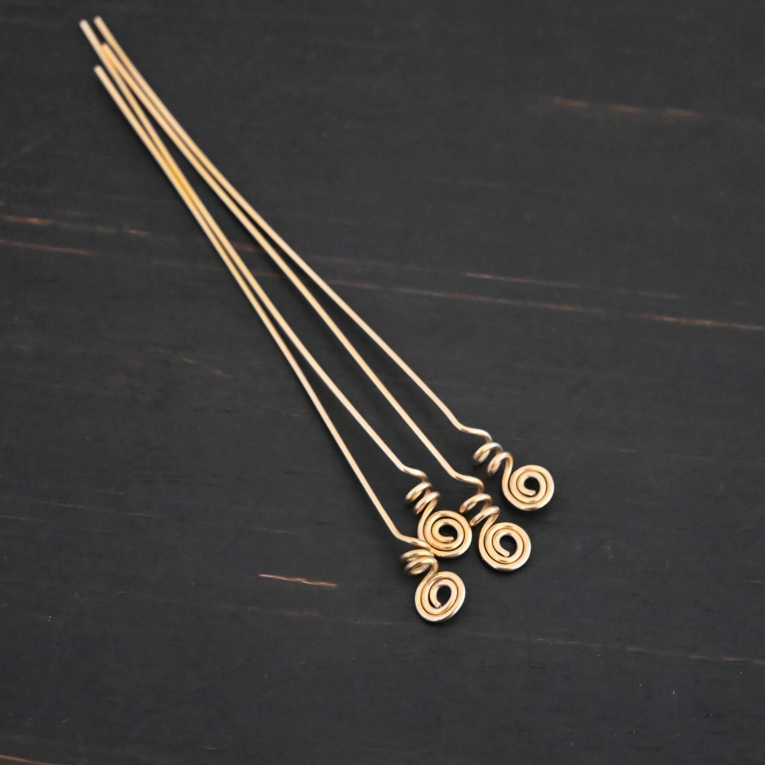 Gold Filled swirl headpin shown on dark background