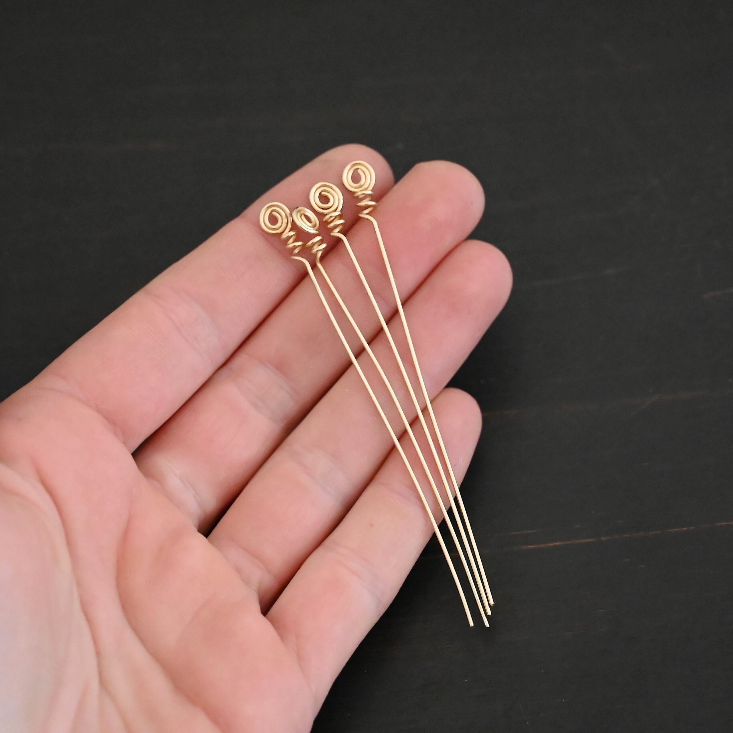 Gold Filled swirl headpin shown in hand