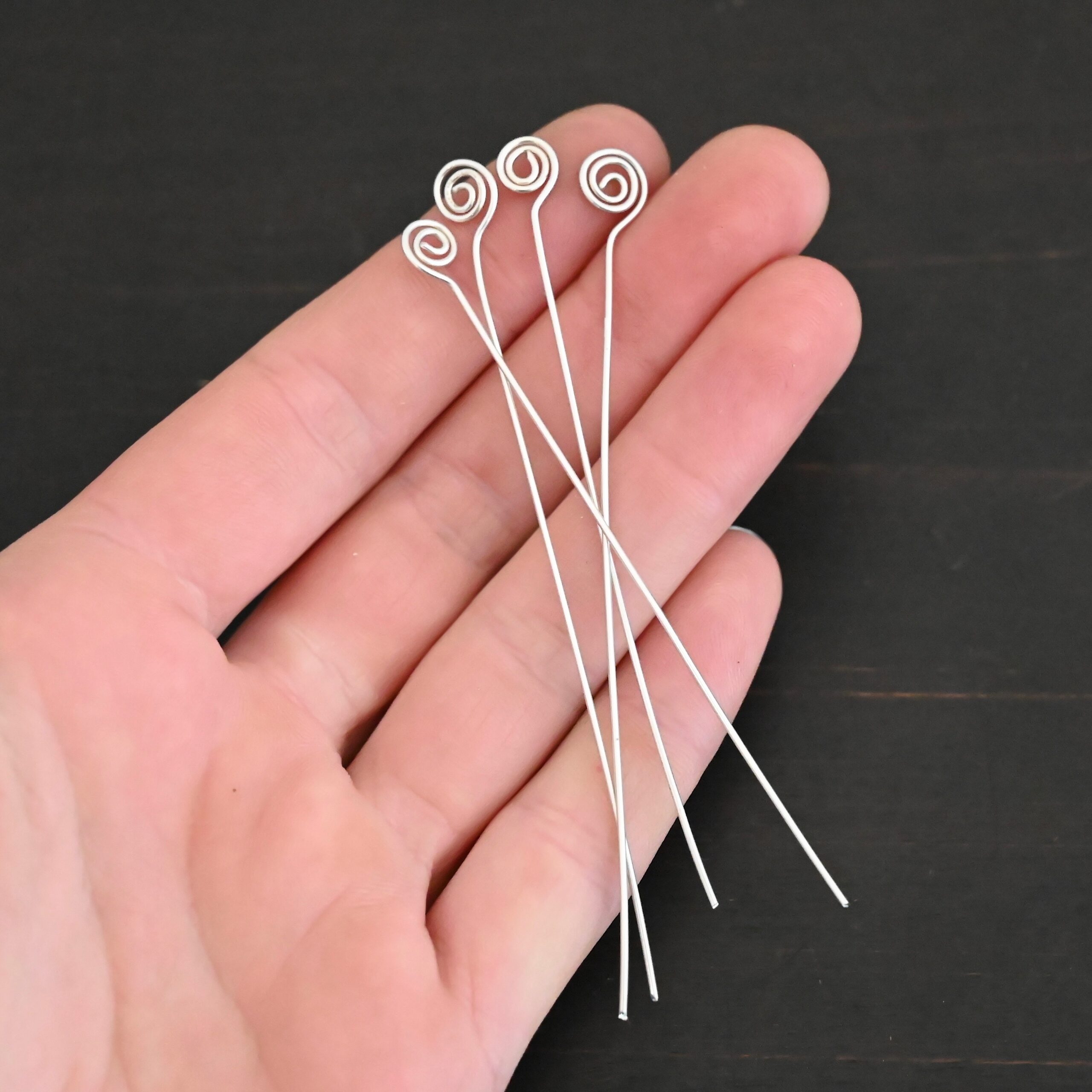 Silver Shiny Swirl headpin shown in hand