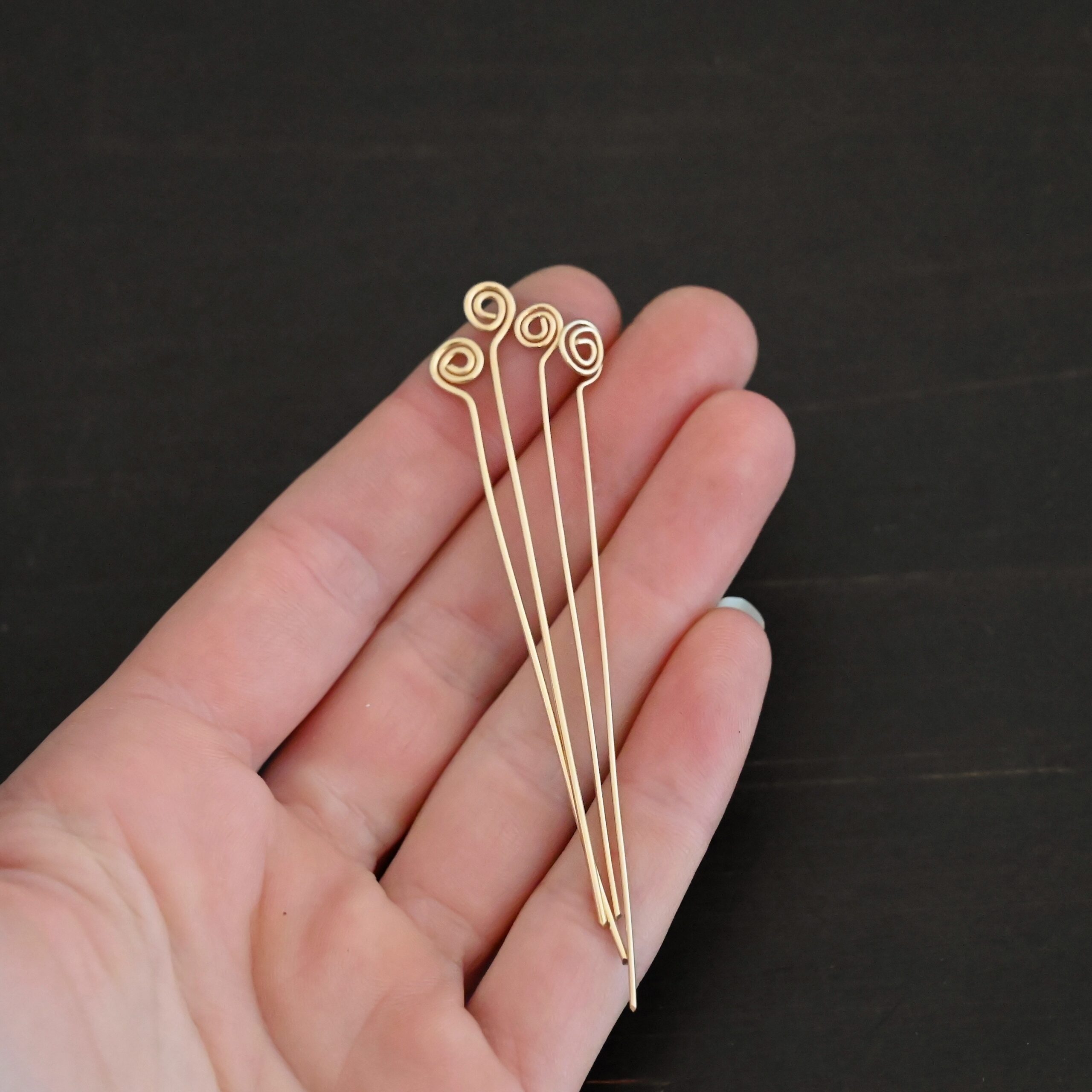 Gold Filled Swirl headpin shown in hand