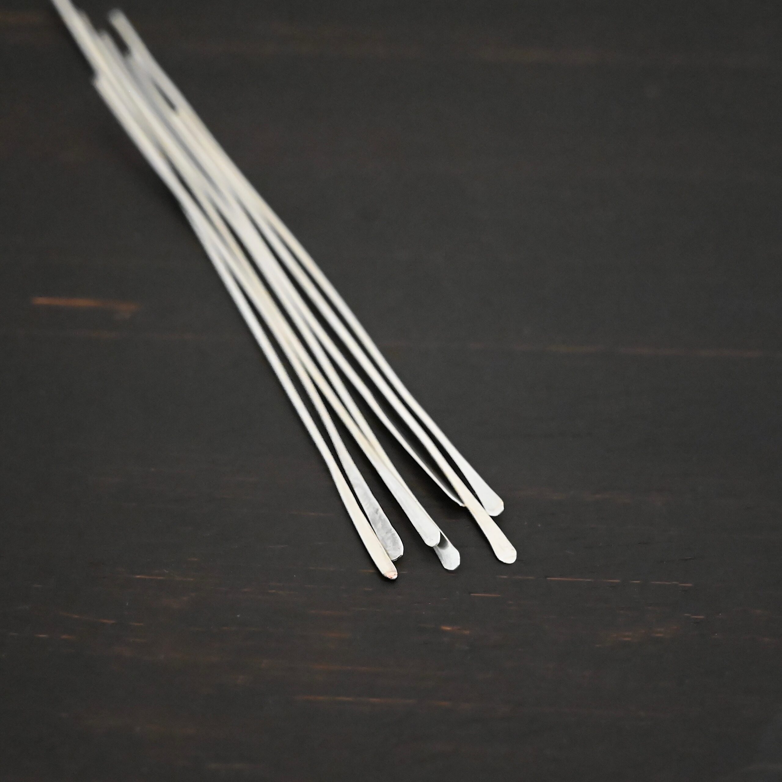 Silver Shiny Paddle headpin shown on dark background