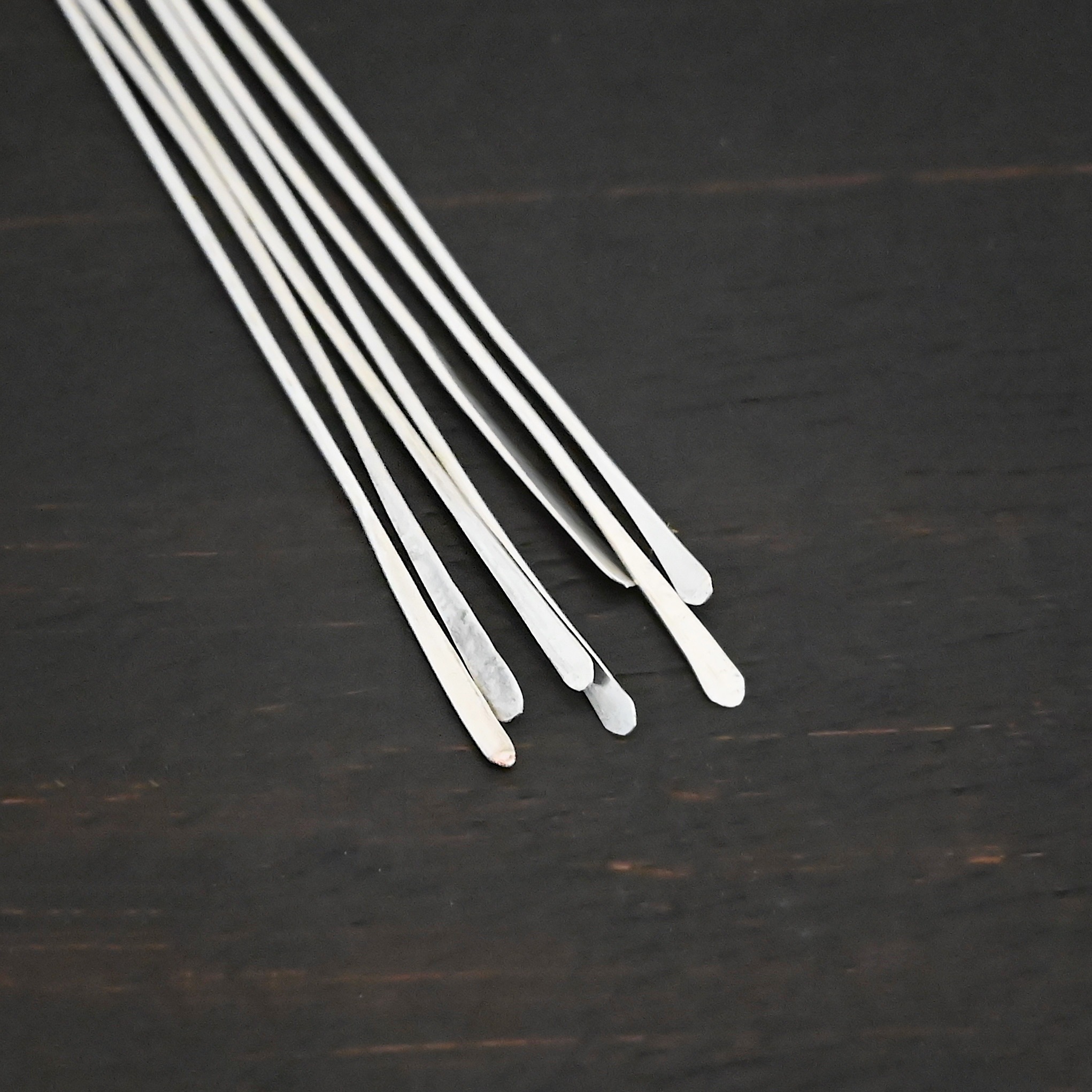 Silver Shiny Paddle headpin shown on dark background