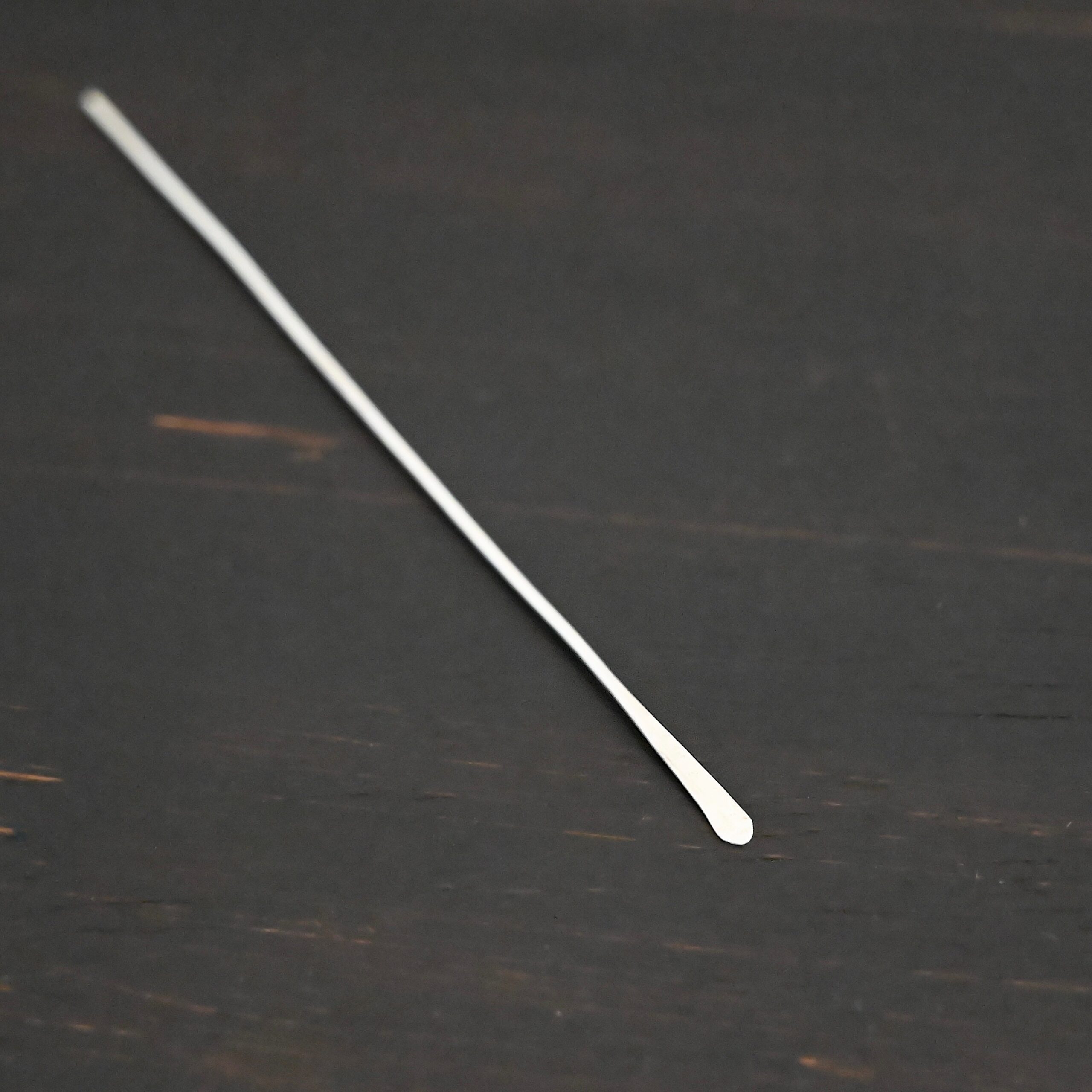 Silver Shiny Paddle headpin shown on dark background
