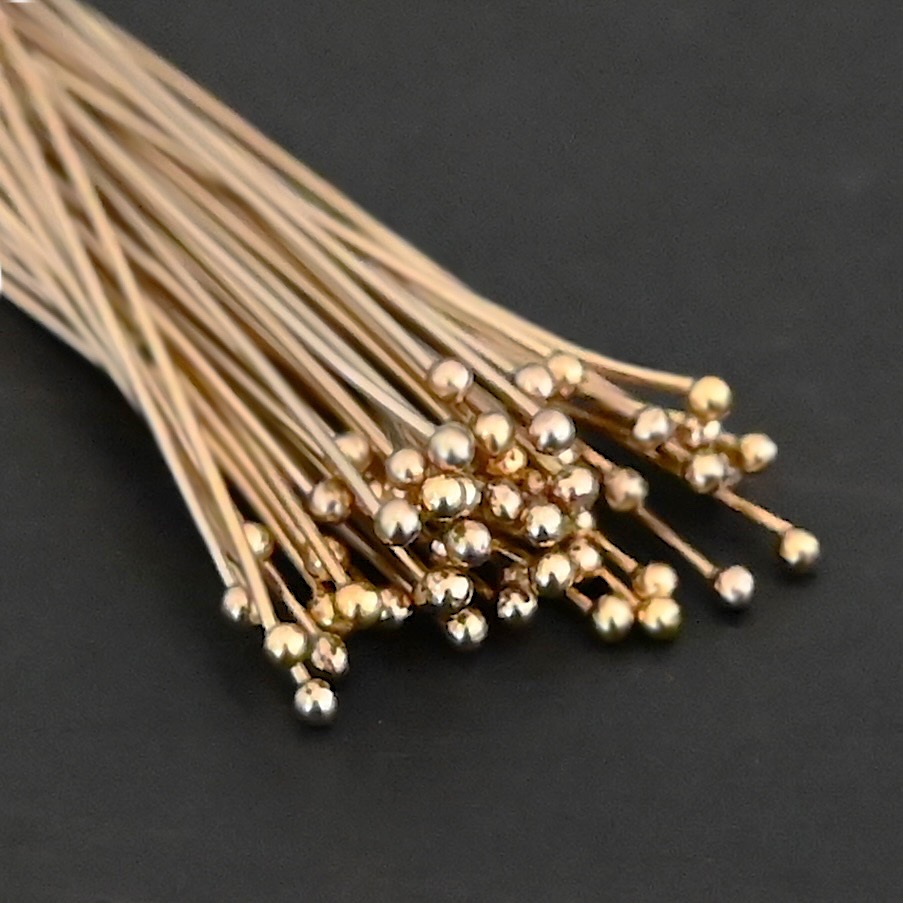 Gold Filled Ball Headpins shown on dark background