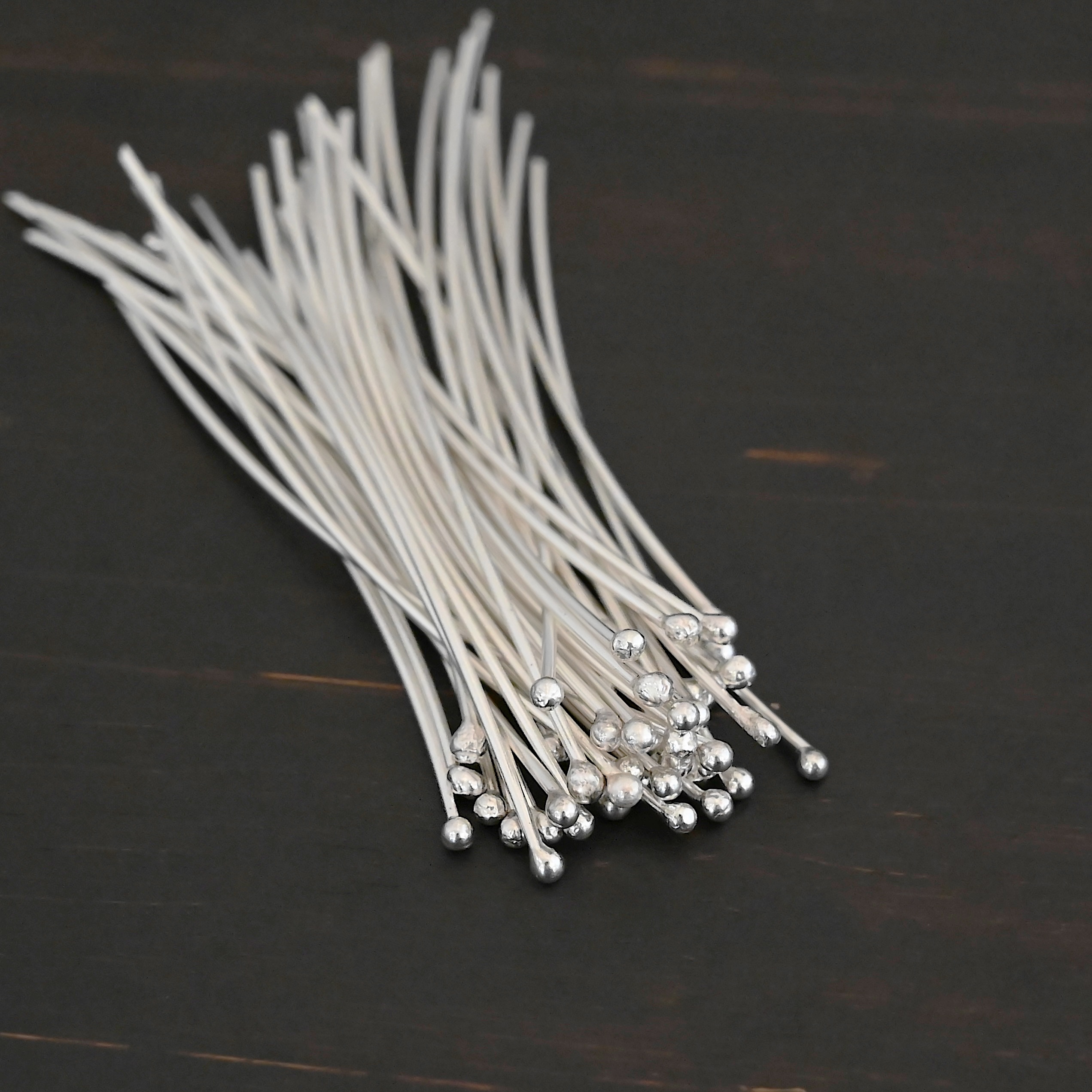 Large Shiny Ball Headpins shown on dark background