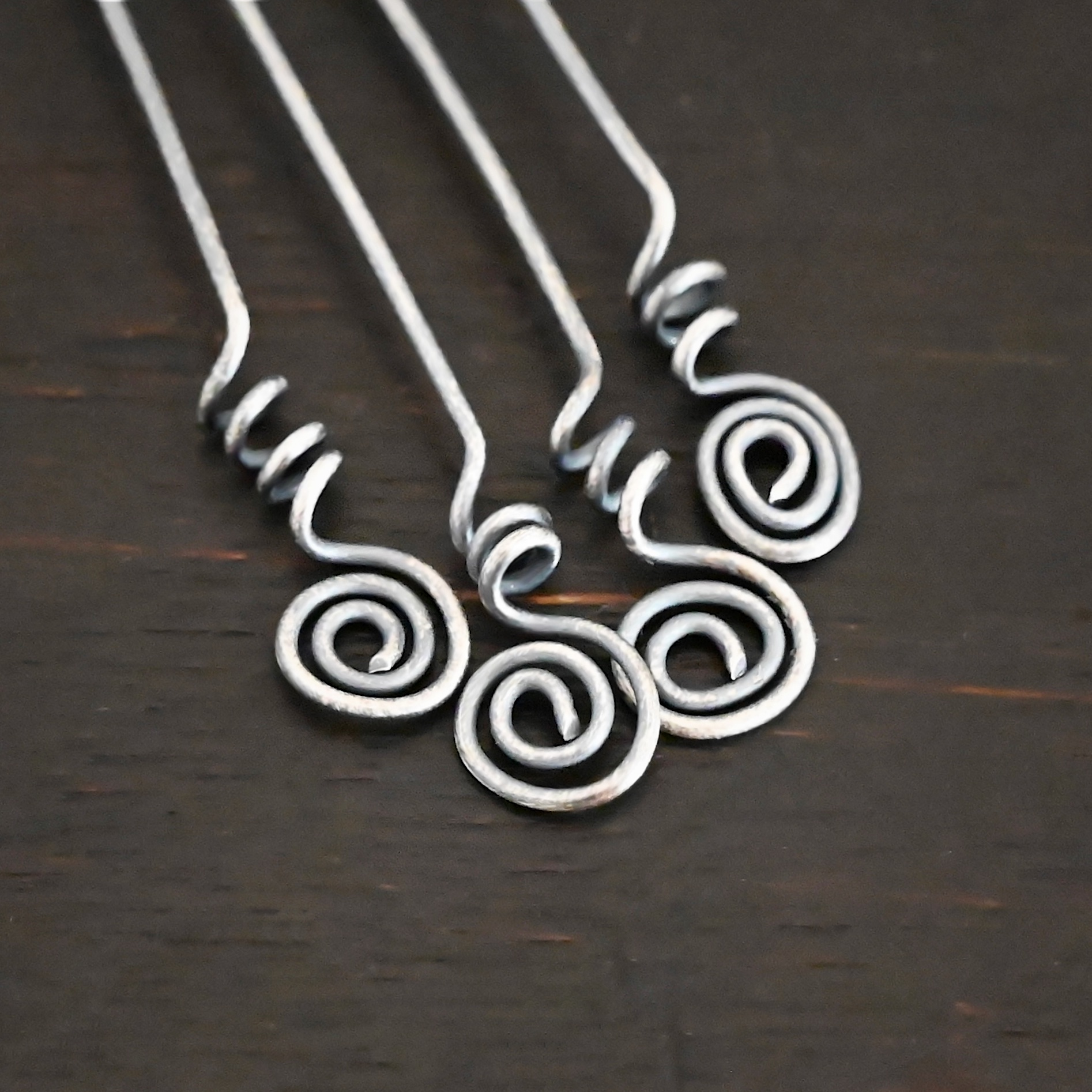 Silver Oxidized Swirl Headpins shown on dark background