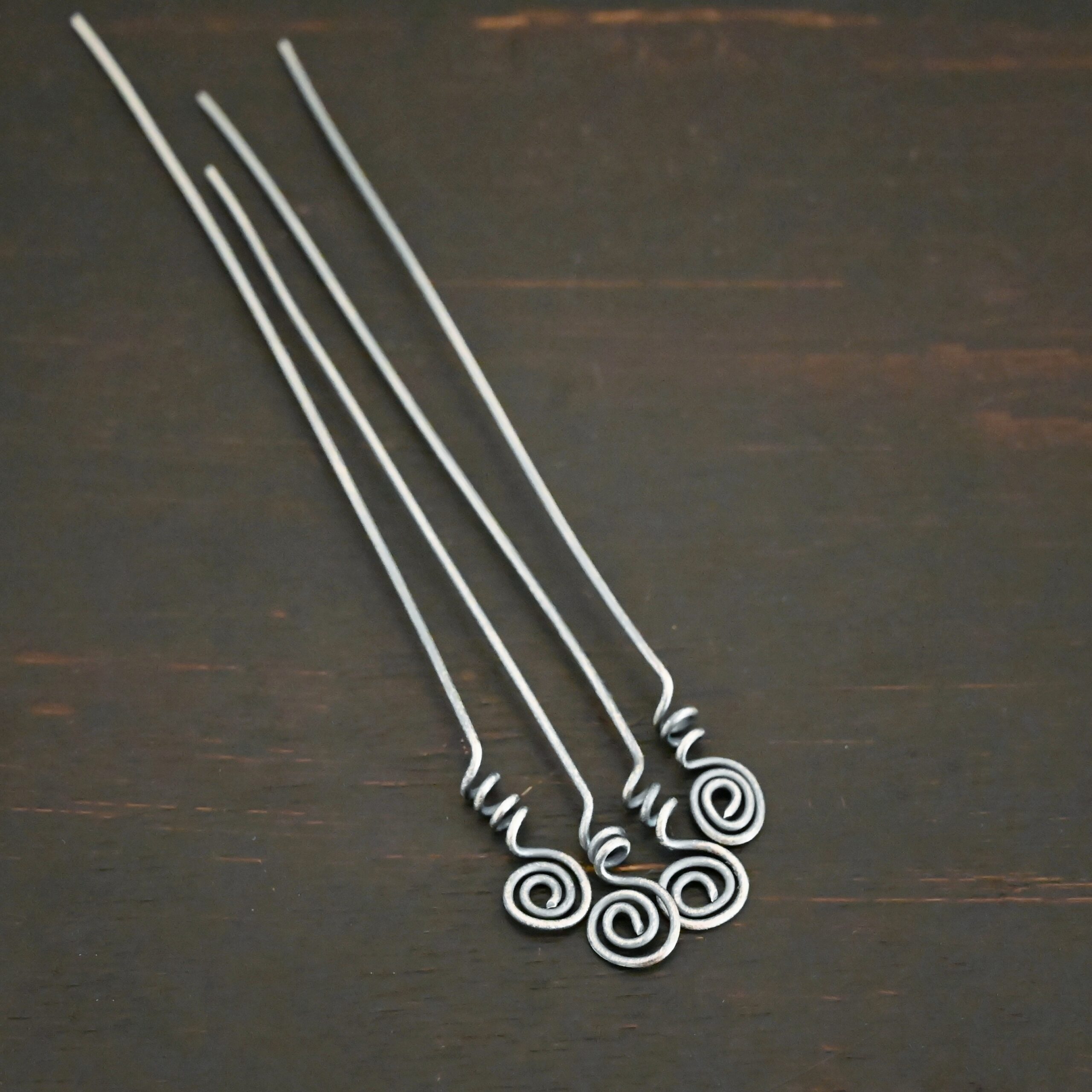 Silver Oxidized Swirl Headpins shown on dark background