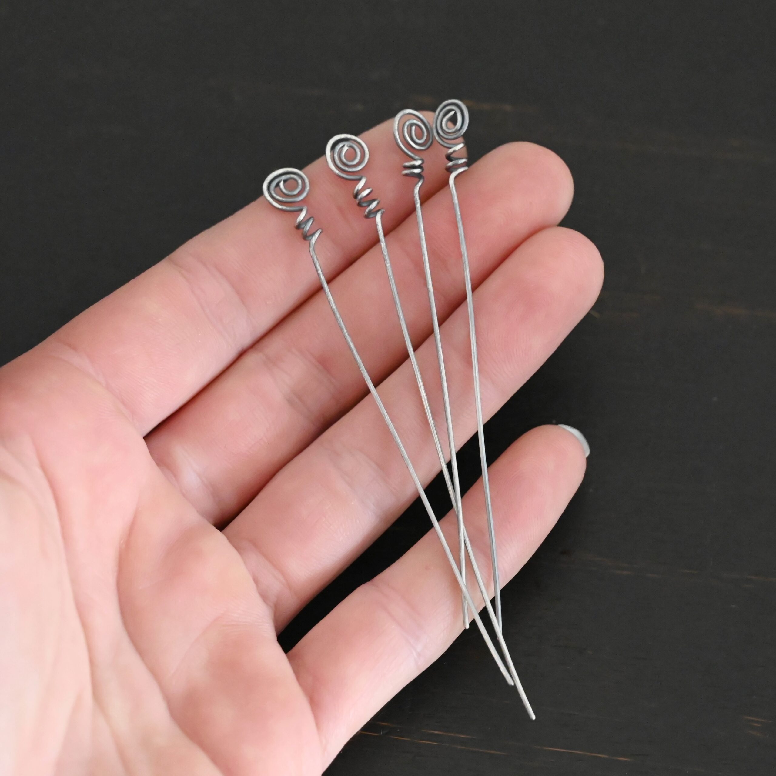 Silver Oxidized Swirl Headpins shown in hand