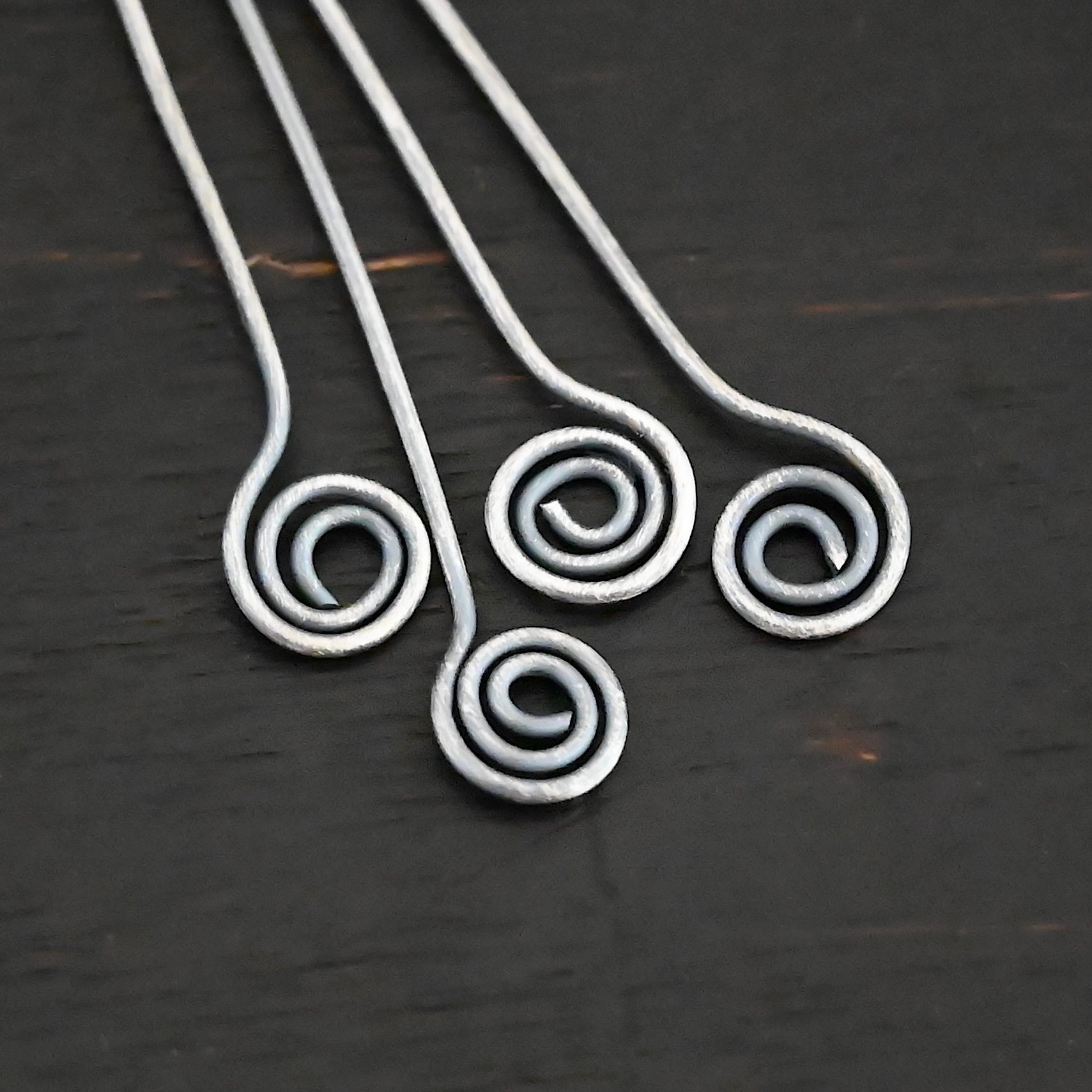 Silver Oxidized Swirl Headpins shown in dark background