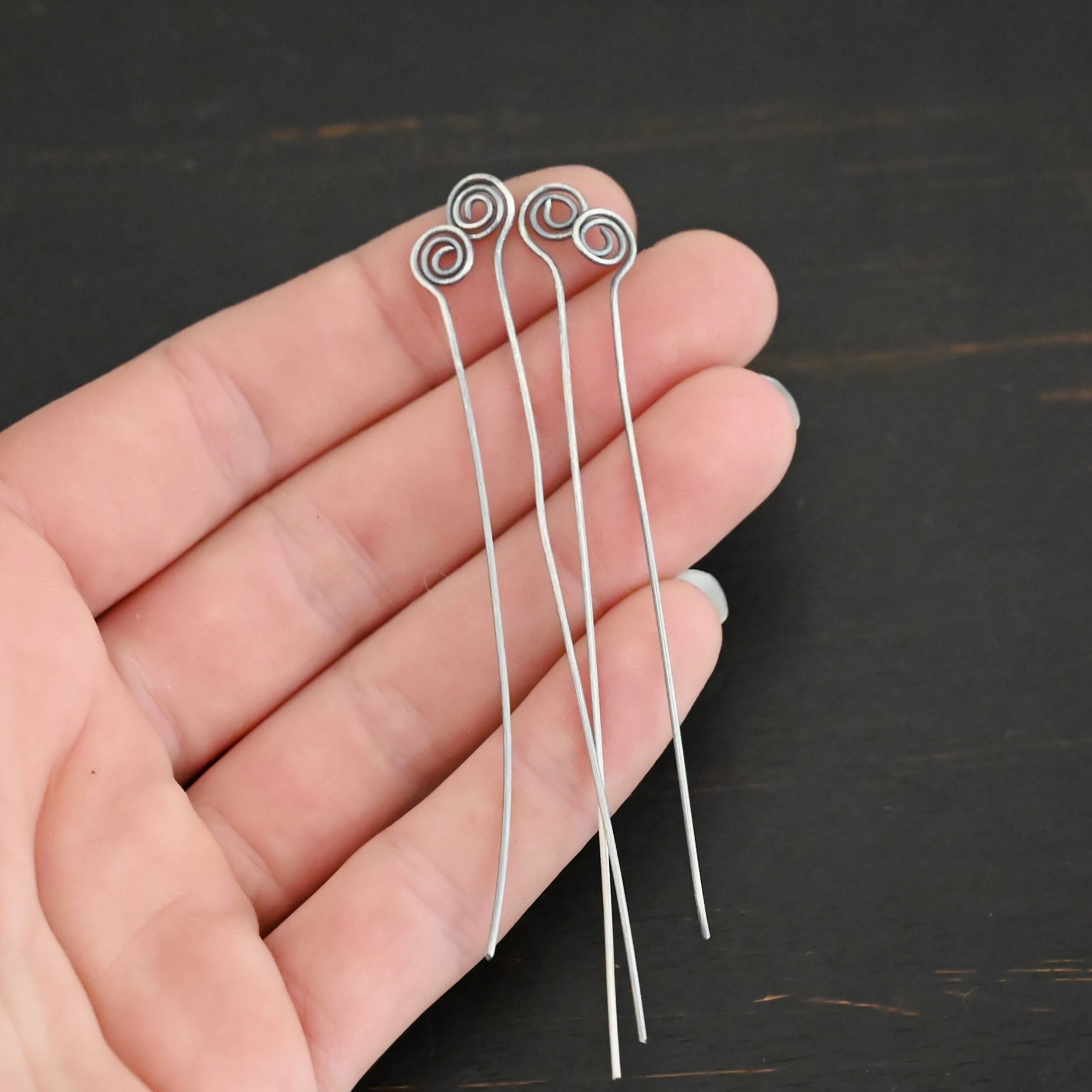 Silver Oxidized Swirl Headpins shown in hand