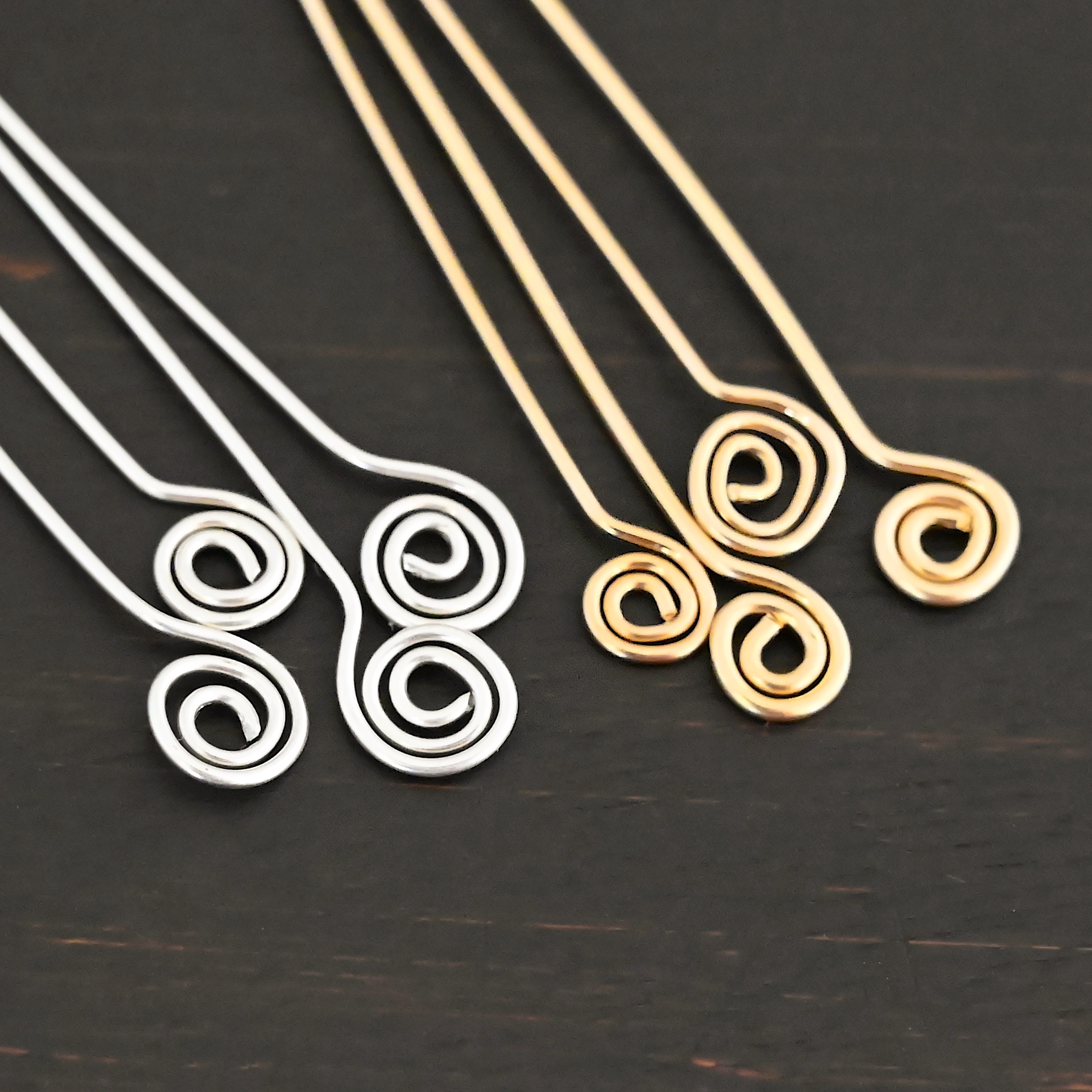 Silver shiny & gold filled Swirl Headpin shown on dark background