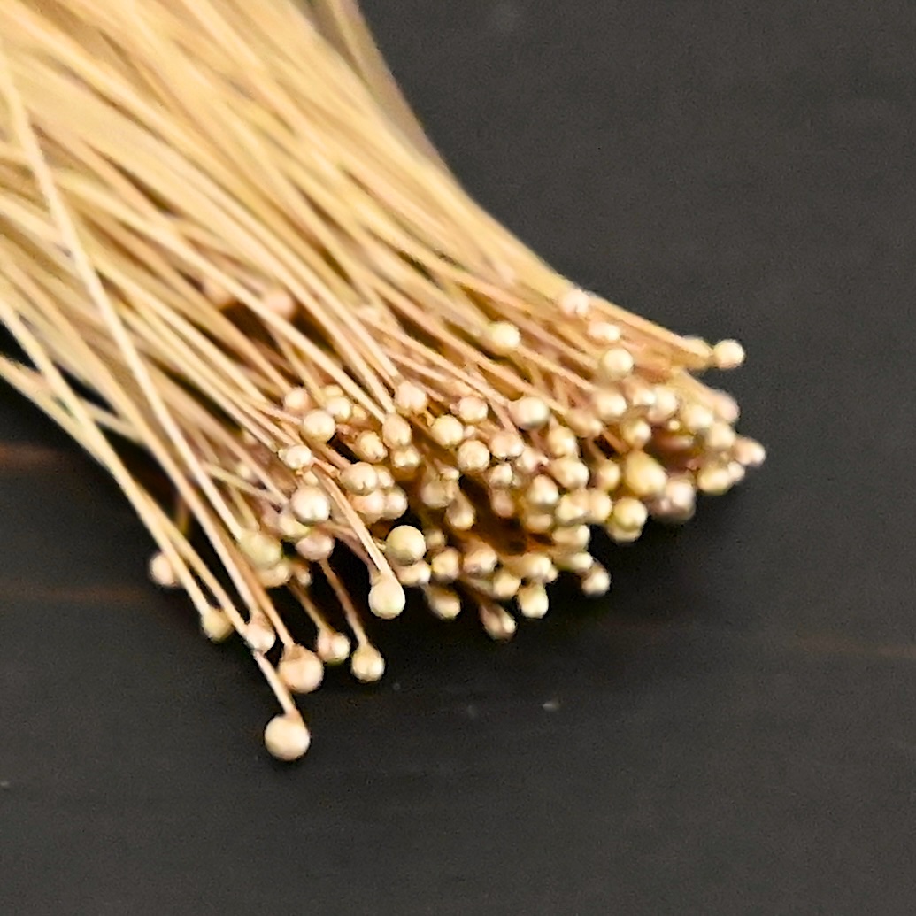 14k gold 30 gauge ball headpins shown on dark background