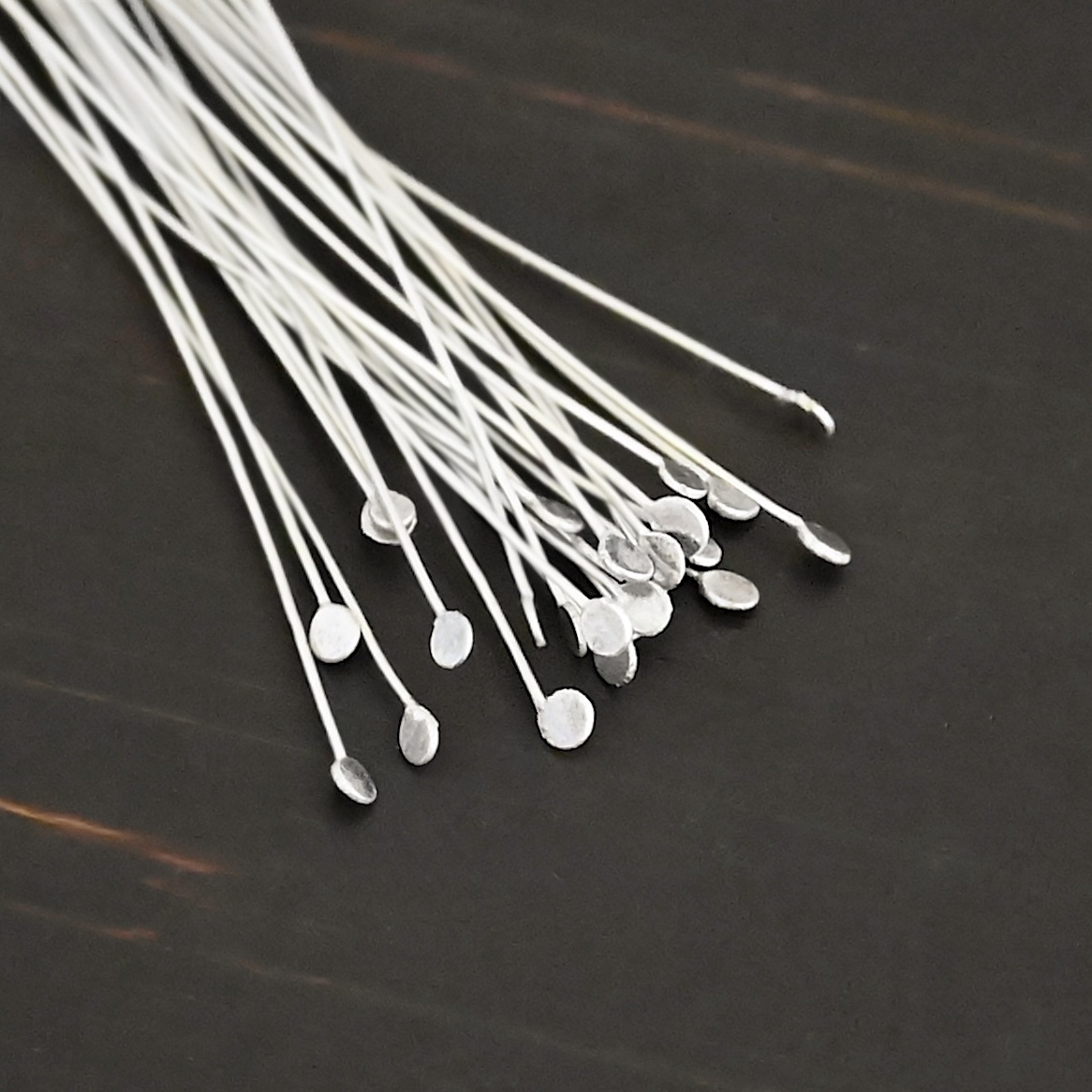 Round Dot Headpin Shiny Silver Shiny Round Dot headpins shown on dark background