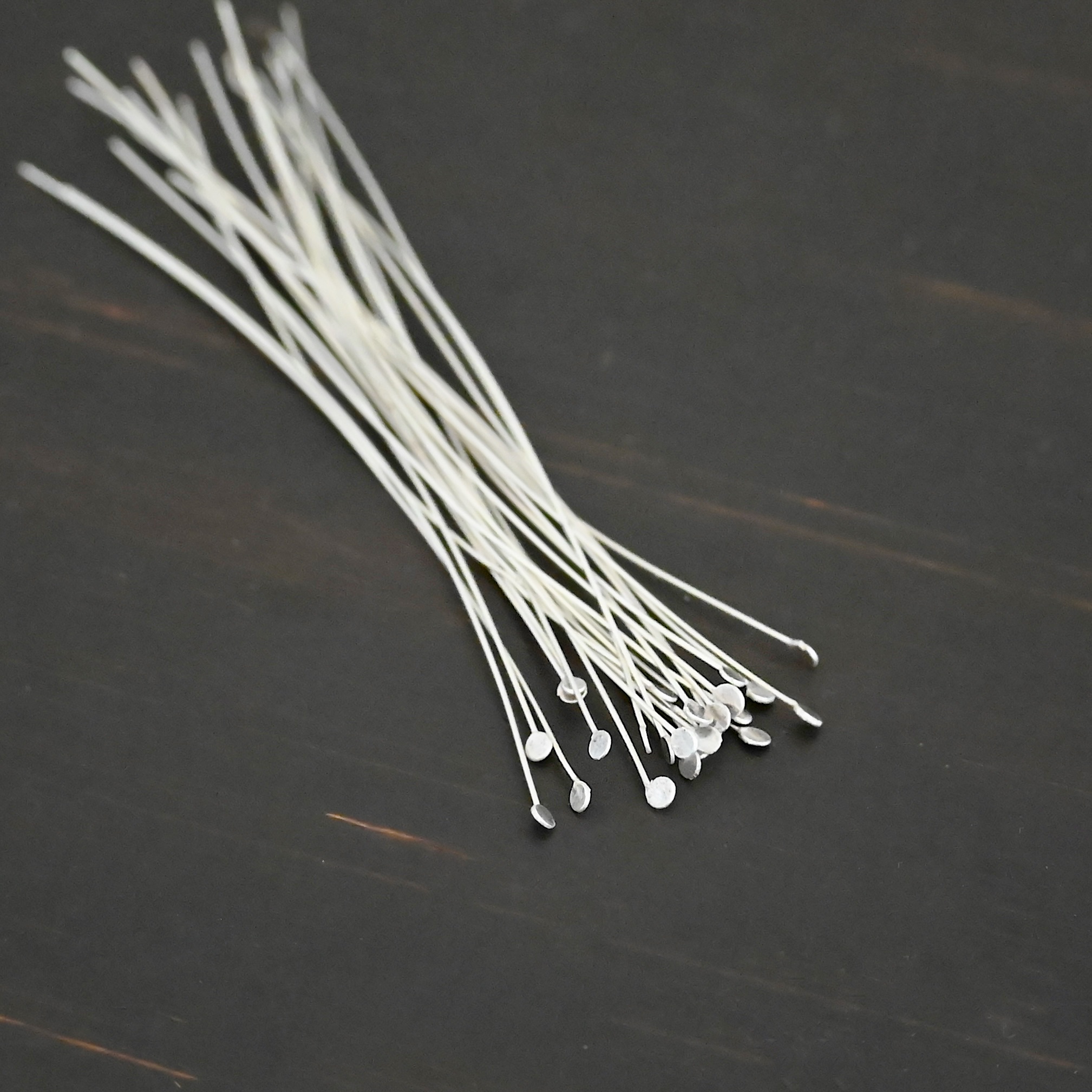 Round Dot Headpin Shiny Silver Shiny Round Dot headpins shown on dark background