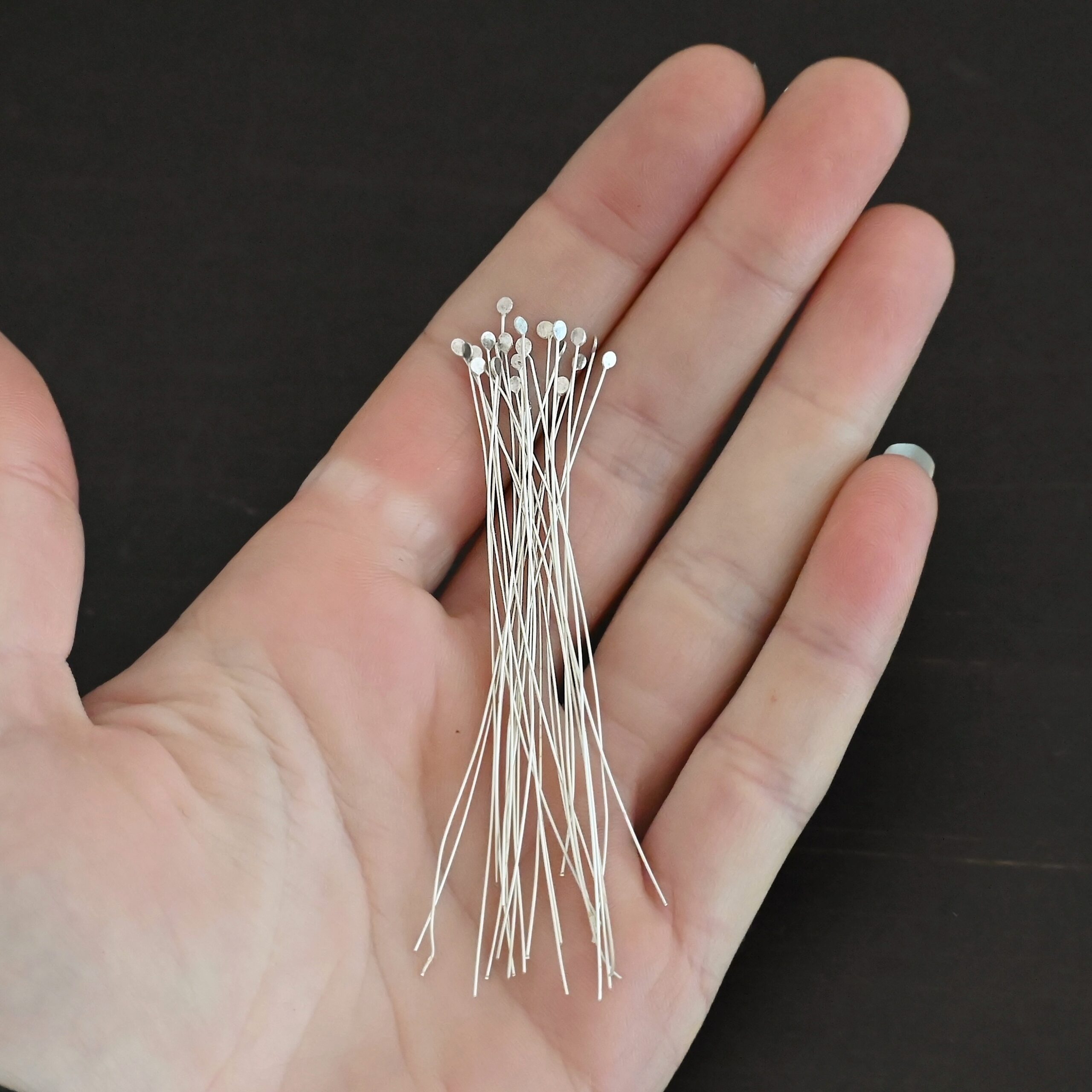 Round Dot Headpin Shiny Silver Shiny Round Dot headpins shown in hand