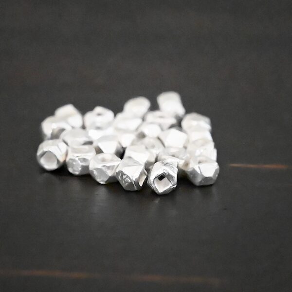 Silver Shiny cubed Beads shown on dark background
