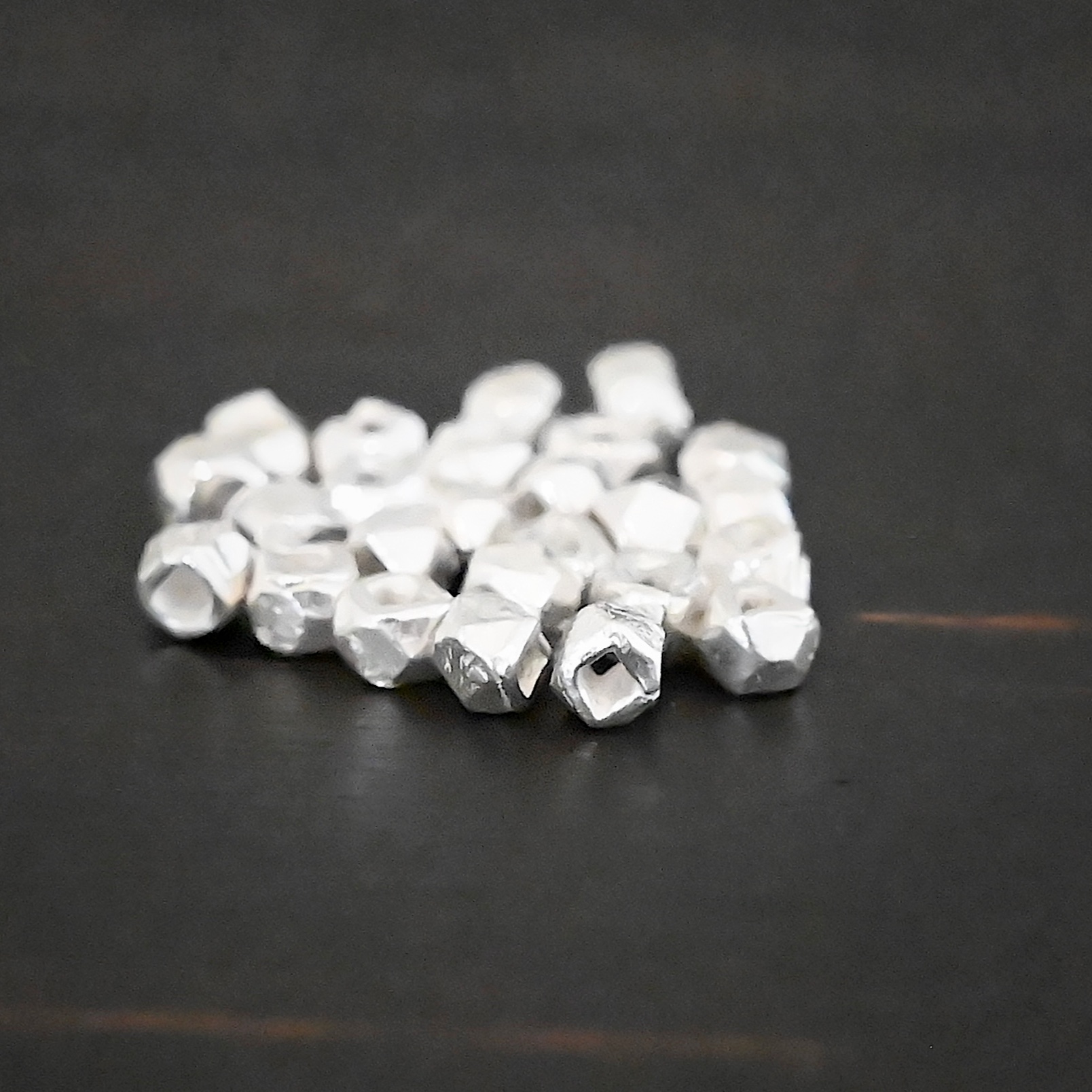 Cubed Bead shiny Silver Shiny cubed Beads shown on dark background