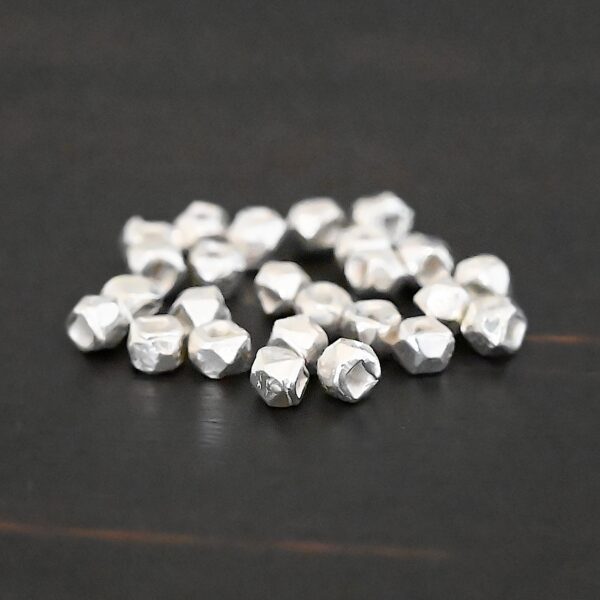 Silver Shiny cubed Beads shown on dark background