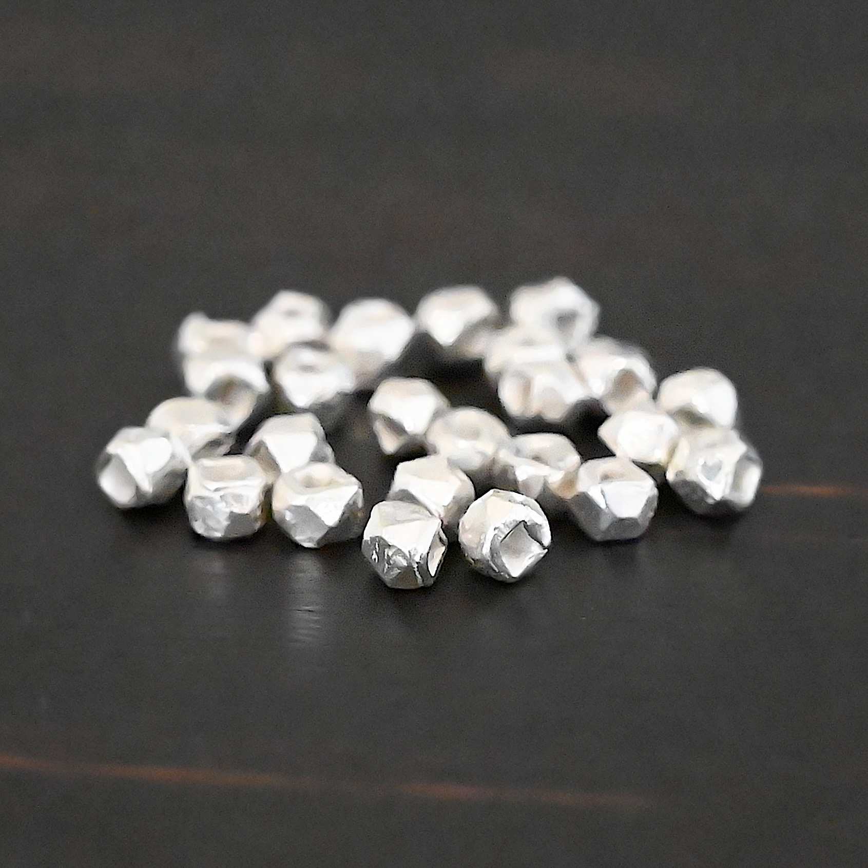 Cubed Bead shiny Silver Shiny cubed Beads shown on dark background