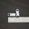 Handmade silver 6mm oxidized end caps shown by ruler