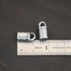 Handmade silver 5mm oxidized end caps shown by ruler