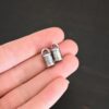 Handmade silver 5mm oxidized end caps shown in hand