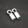 Silver shiny end caps shown on dark background