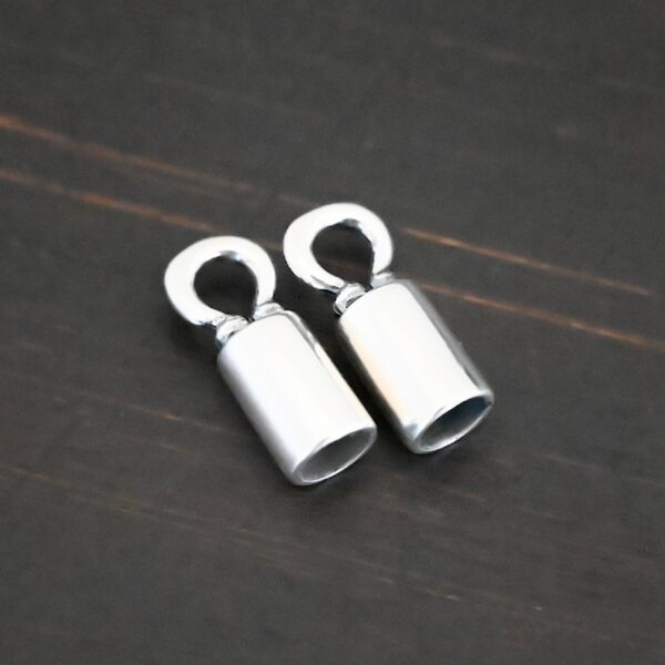 Silver shiny end caps shown on dark background