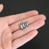 Silver oxidized end caps shown in hand