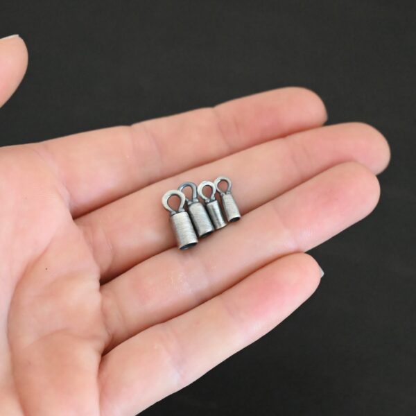 Silver oxidized end caps shown in hand