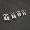 Silver oxidized end caps shown on dark background