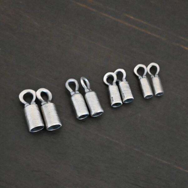 Silver oxidized end caps shown on dark background